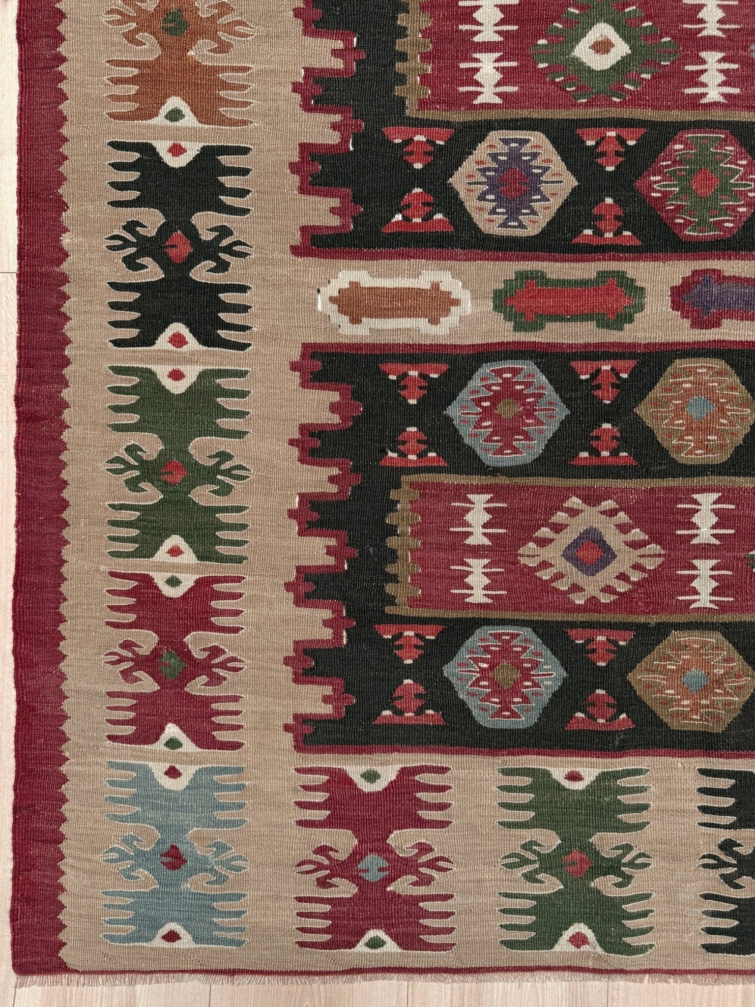 Handmade vintage Pirot Sharkoy kilim rug from the Balkans, approx. 8x10, with garnet red geometric bands, ivory tribal border, and charcoal, sage, and dusty blue motifs.