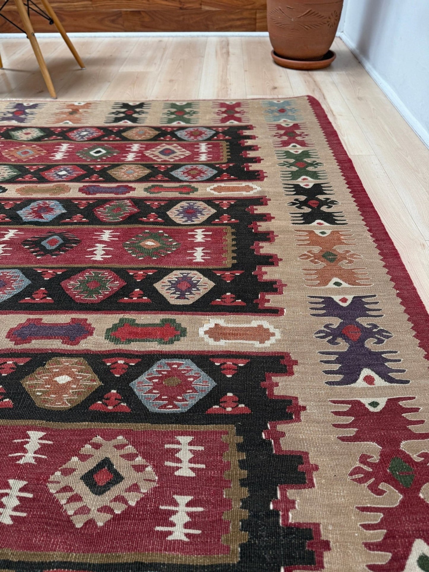 Handmade vintage Pirot Sharkoy kilim rug from the Balkans, approx. 8x10, with garnet red geometric bands, ivory tribal border, and charcoal, sage, and dusty blue motifs.