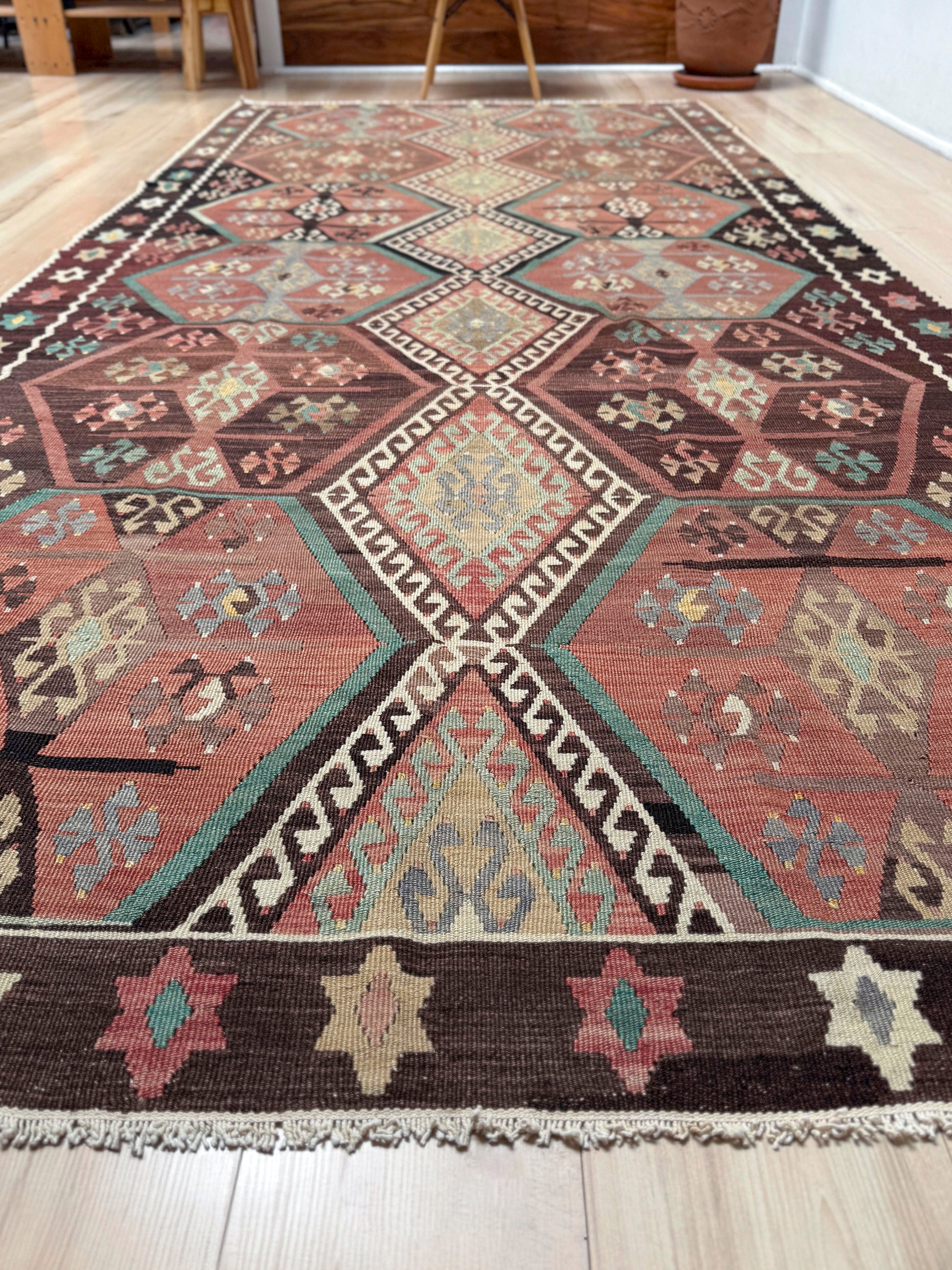 Vintage Kayseri Turkish kilim rug with earthy colors and blue-gray geometric medallions, handmade wool flatweave 5x11 from Indigo Rugs Burlingame Bay Area.