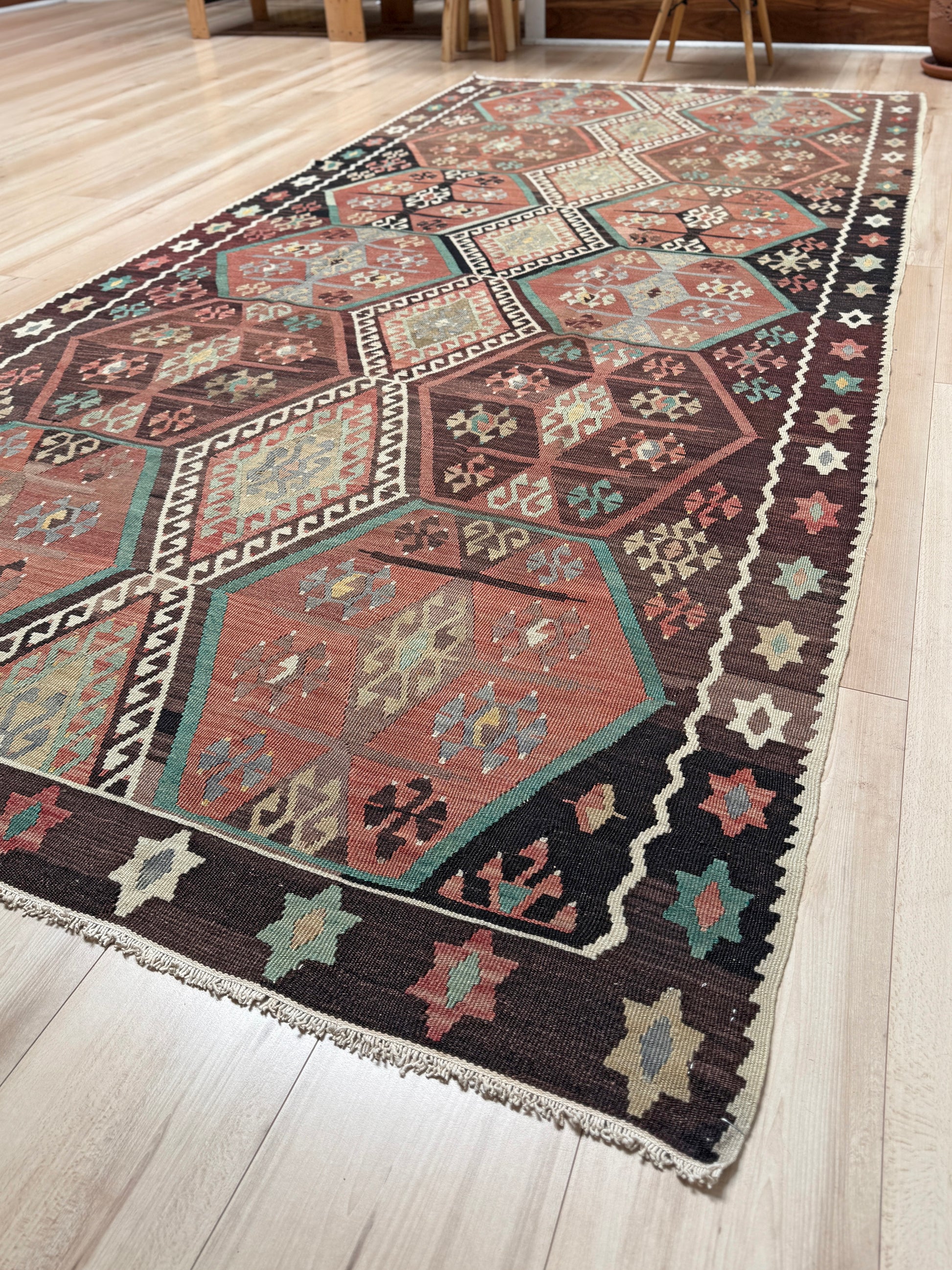 Vintage Kayseri Turkish kilim rug with earthy colors and blue-gray geometric medallions, handmade wool flatweave 5x11 from Indigo Rugs Burlingame Bay Area.