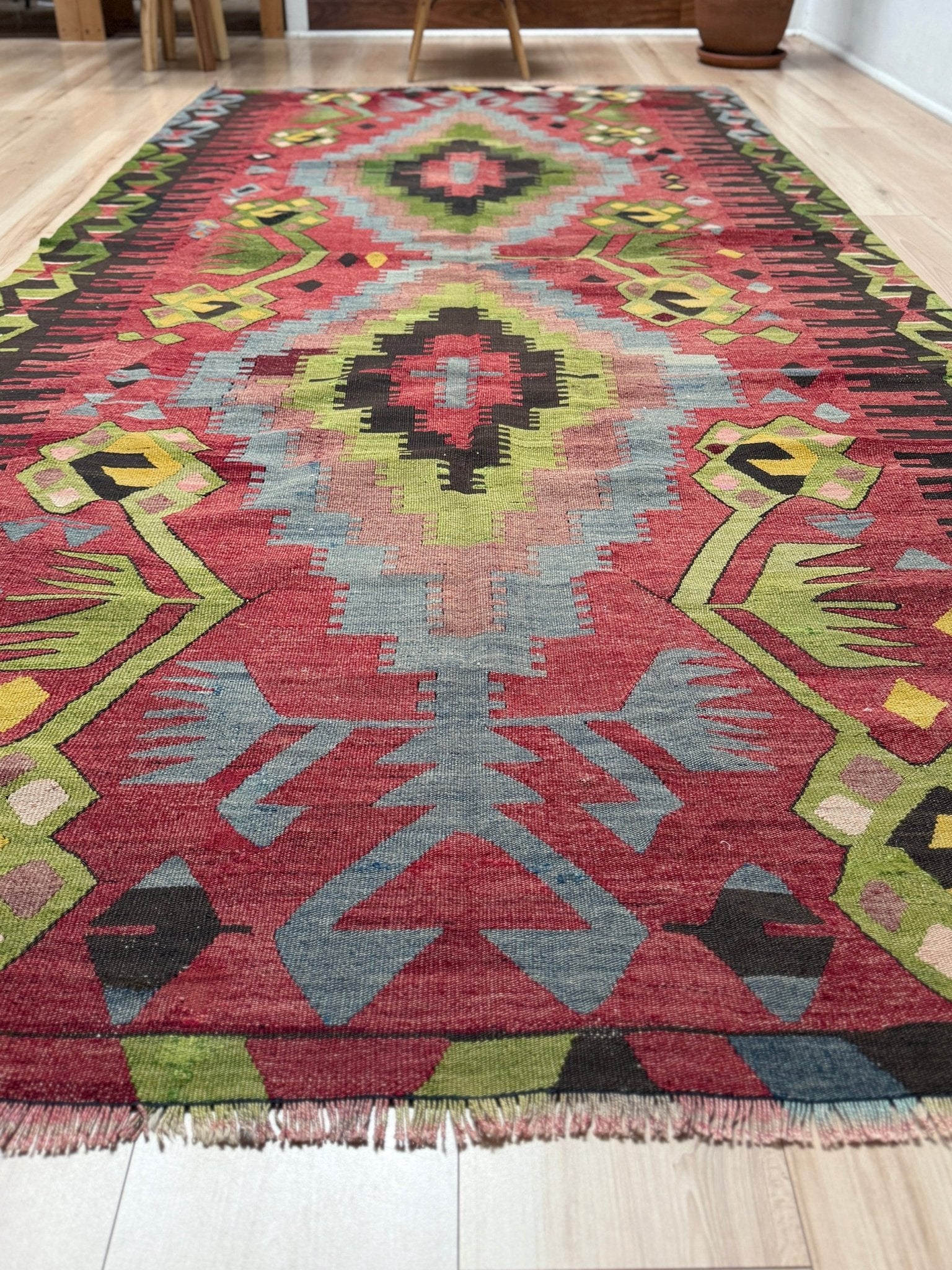 Vintage Esme Turkish kilim rug featuring in madder red, olive green colors, geometric medallions, handmade Anatolian wool flatweave rug measuring 6x10 in excellent vintage condition.