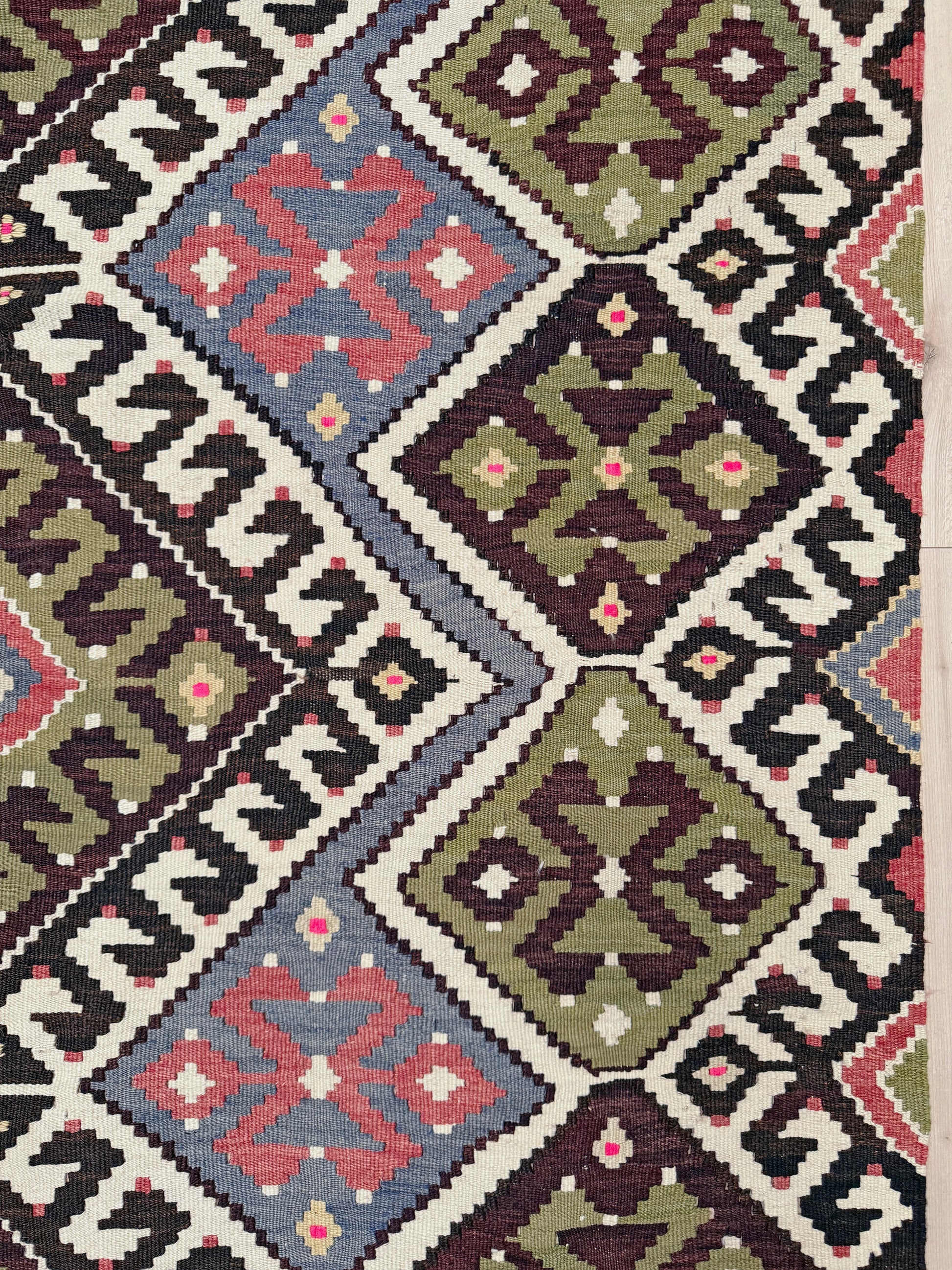 Vintage Esme Turkish kilim rug with repeating diamond medallions in muted olive green, deep plum, dusty periwinkle blue, handmade wool flatweave 6x12 from Indigo Rugs Burlingame Bay Area.