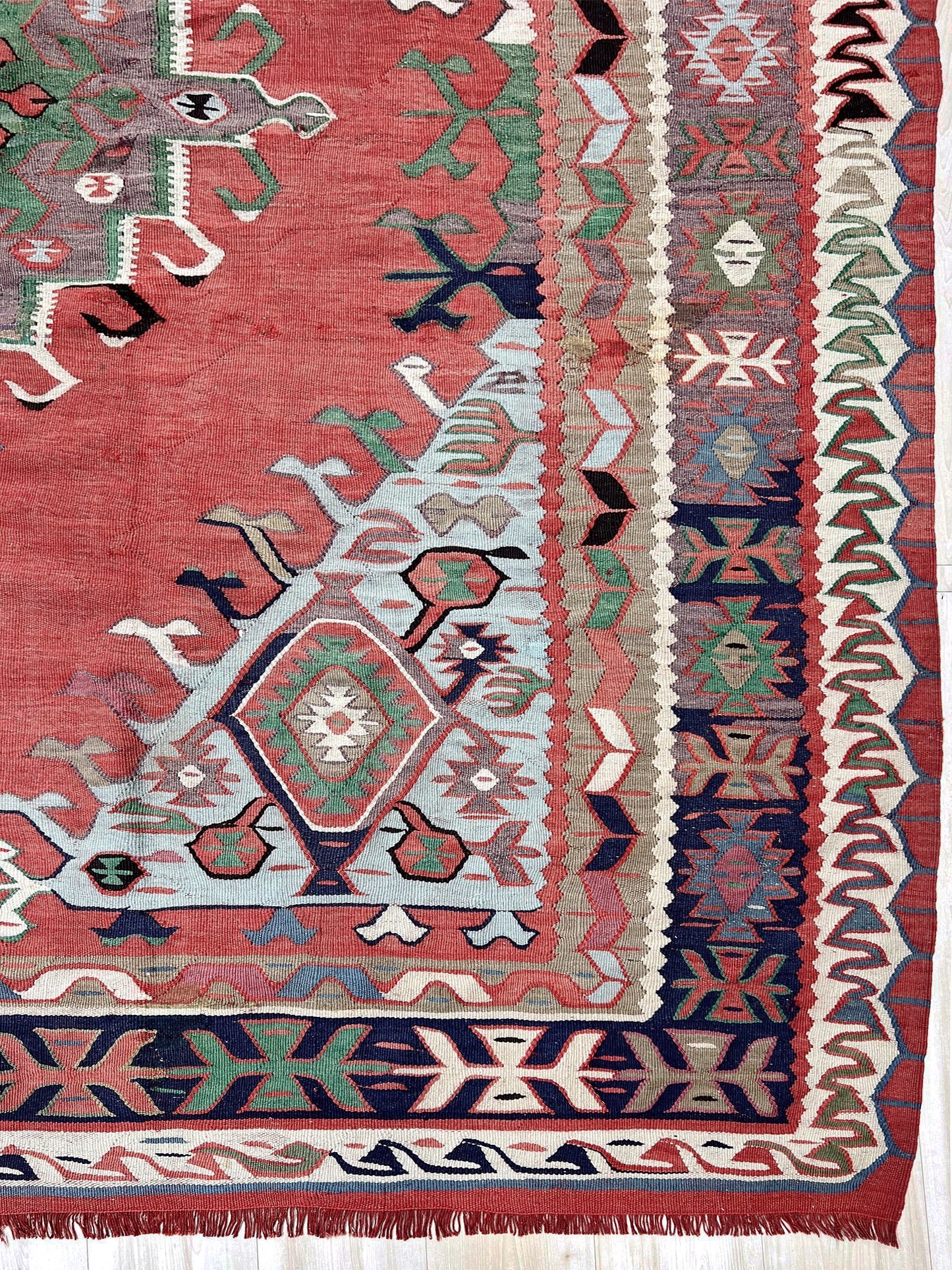 4x10 vintage Turkish Oushak kilim rug with a dusty rose field, geometric tribal medallion, and soft sage, mint, and blue accents — handmade flatweave wool rug from the 1940s, naturally dyed and beautifully aged with mellowed colors and small, well-executed repairs. Perfect for living room or bohemian interior décor — Indigo Rugs.