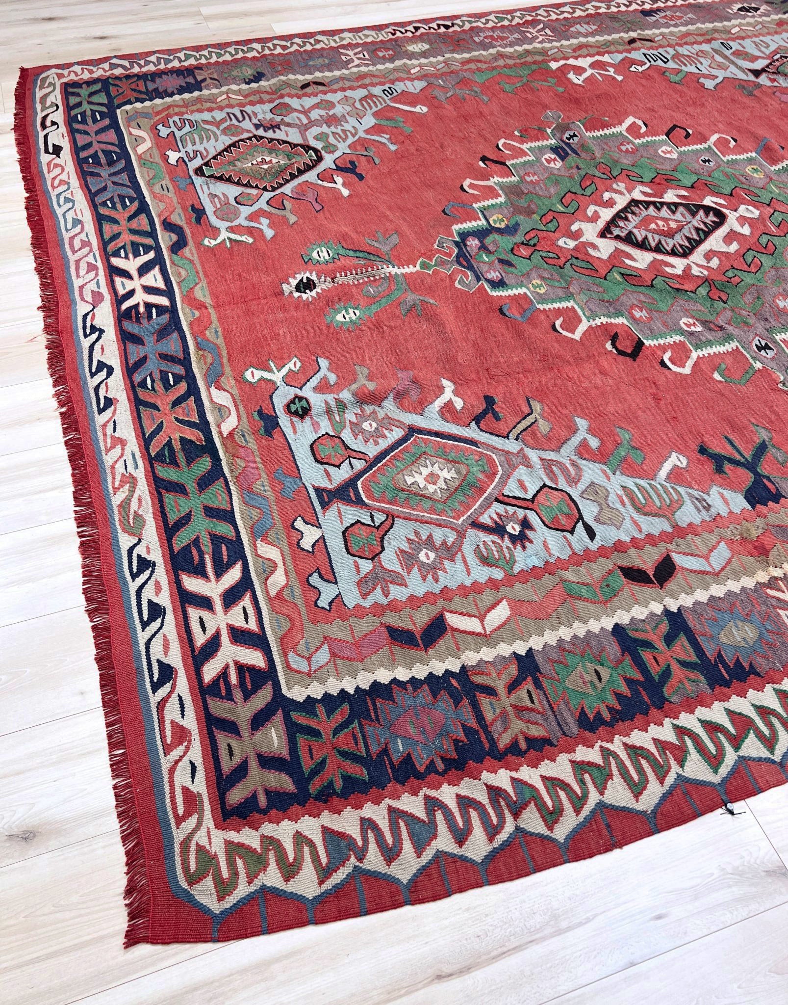 4x10 vintage Turkish Oushak kilim rug with a dusty rose field, geometric tribal medallion, and soft sage, mint, and blue accents — handmade flatweave wool rug from the 1940s, naturally dyed and beautifully aged with mellowed colors and small, well-executed repairs. Perfect for living room or bohemian interior décor — Indigo Rugs.