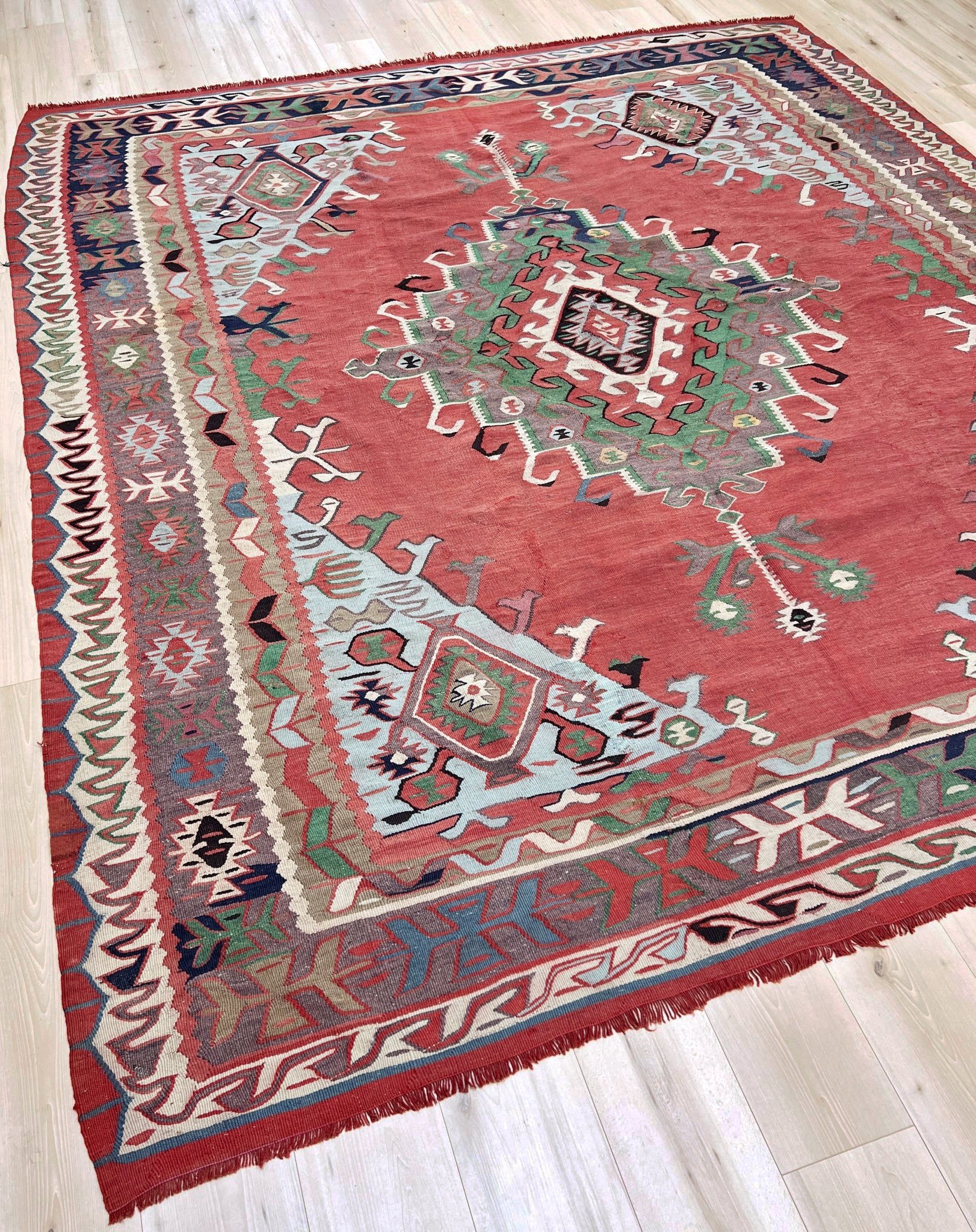 4x10 vintage Turkish Oushak kilim rug with a dusty rose field, geometric tribal medallion, and soft sage, mint, and blue accents — handmade flatweave wool rug from the 1940s, naturally dyed and beautifully aged with mellowed colors and small, well-executed repairs. Perfect for living room or bohemian interior décor — Indigo Rugs.