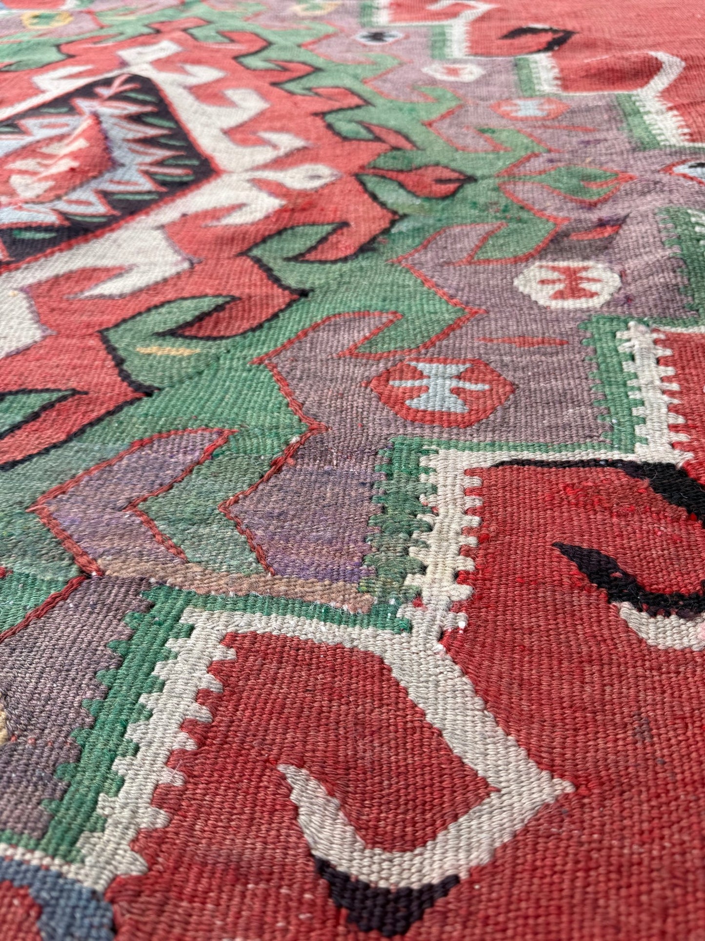 4x10 vintage Turkish Oushak kilim rug with a dusty rose field, geometric tribal medallion, and soft sage, mint, and blue accents — handmade flatweave wool rug from the 1940s, naturally dyed and beautifully aged with mellowed colors and small, well-executed repairs. Perfect for living room or bohemian interior décor — Indigo Rugs.