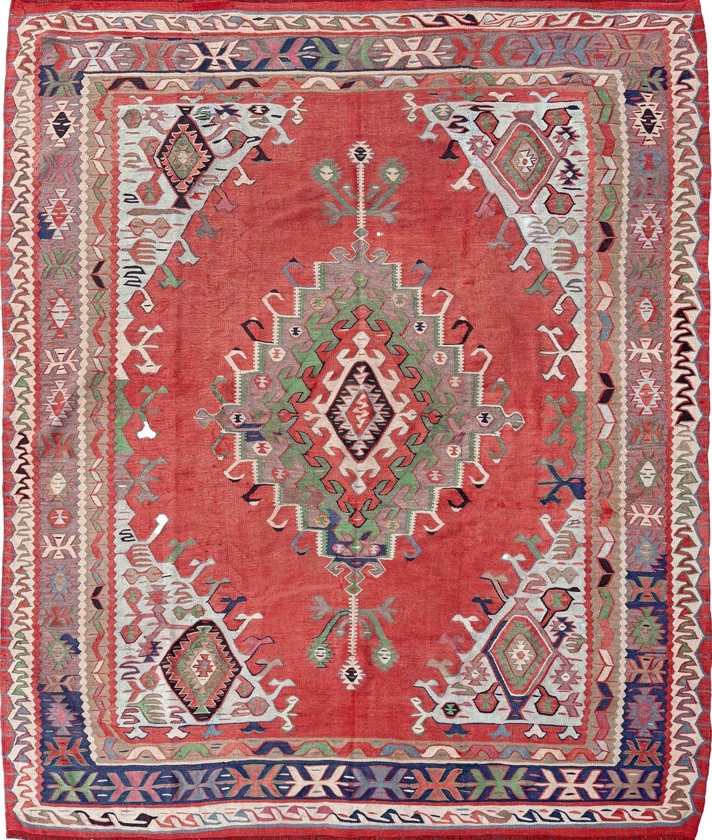 4x10 vintage Turkish Oushak kilim rug with a dusty rose field, geometric tribal medallion, and soft sage, mint, and blue accents — handmade flatweave wool rug from the 1940s, naturally dyed and beautifully aged with mellowed colors and small, well-executed repairs. Perfect for living room or bohemian interior décor — Indigo Rugs.