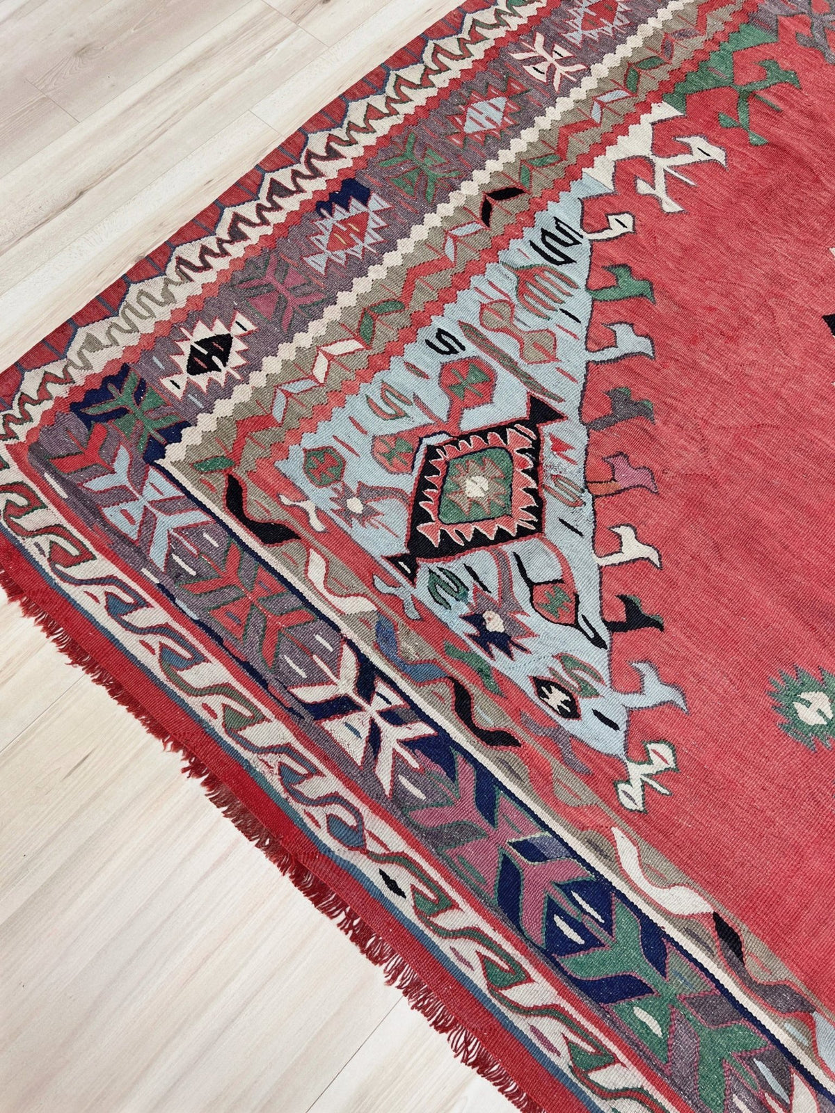 8x10 vintage Turkish Oushak kilim rug with a dusty rose field, geometric tribal medallion, and soft sage, mint, and blue accents — handmade flatweave wool rug from the 1940s