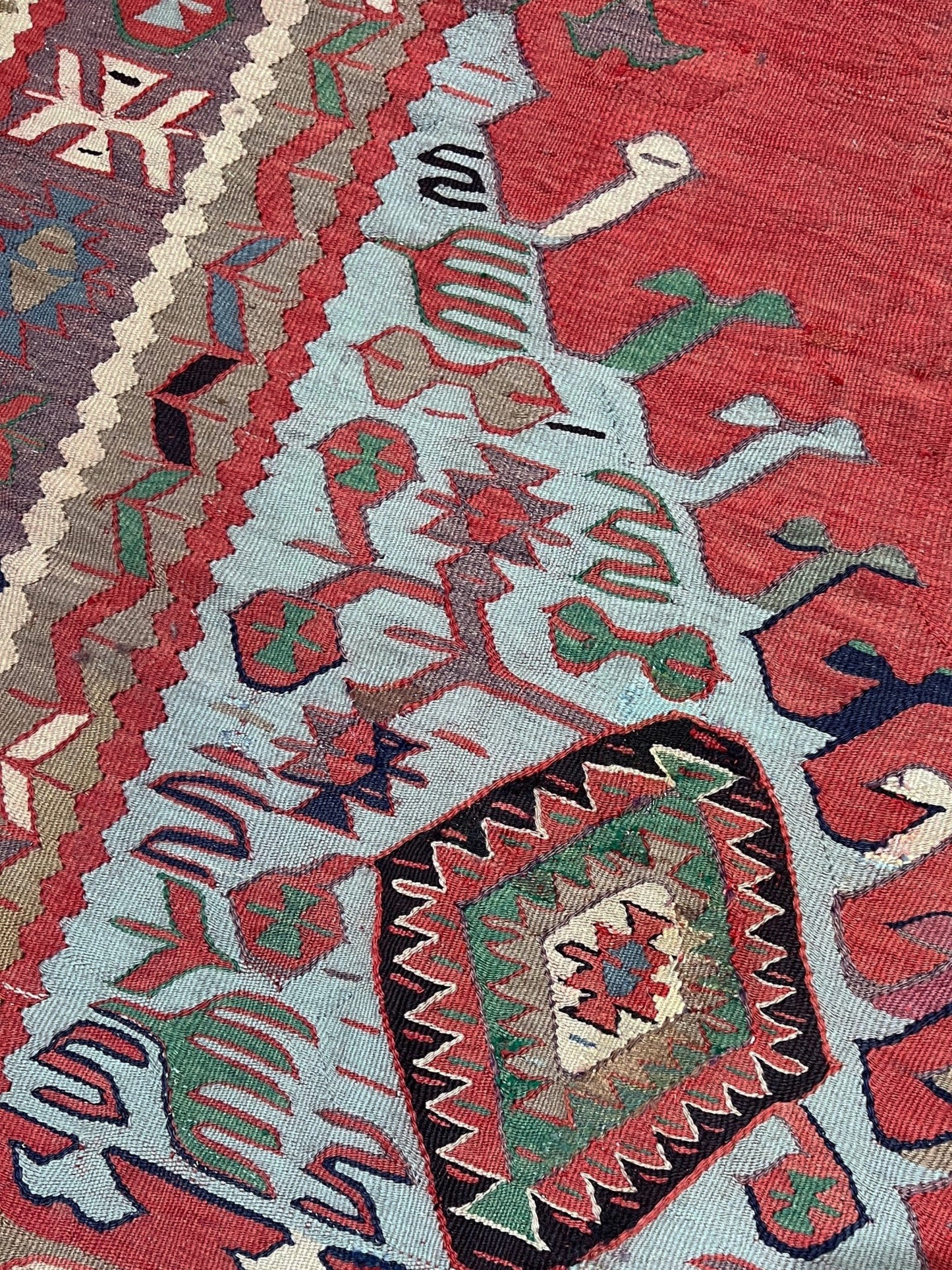 4x10 vintage Turkish Oushak kilim rug with a dusty rose field, geometric tribal medallion, and soft sage, mint, and blue accents — handmade flatweave wool rug from the 1940s, naturally dyed and beautifully aged with mellowed colors and small, well-executed repairs. Perfect for living room or bohemian interior décor — Indigo Rugs.