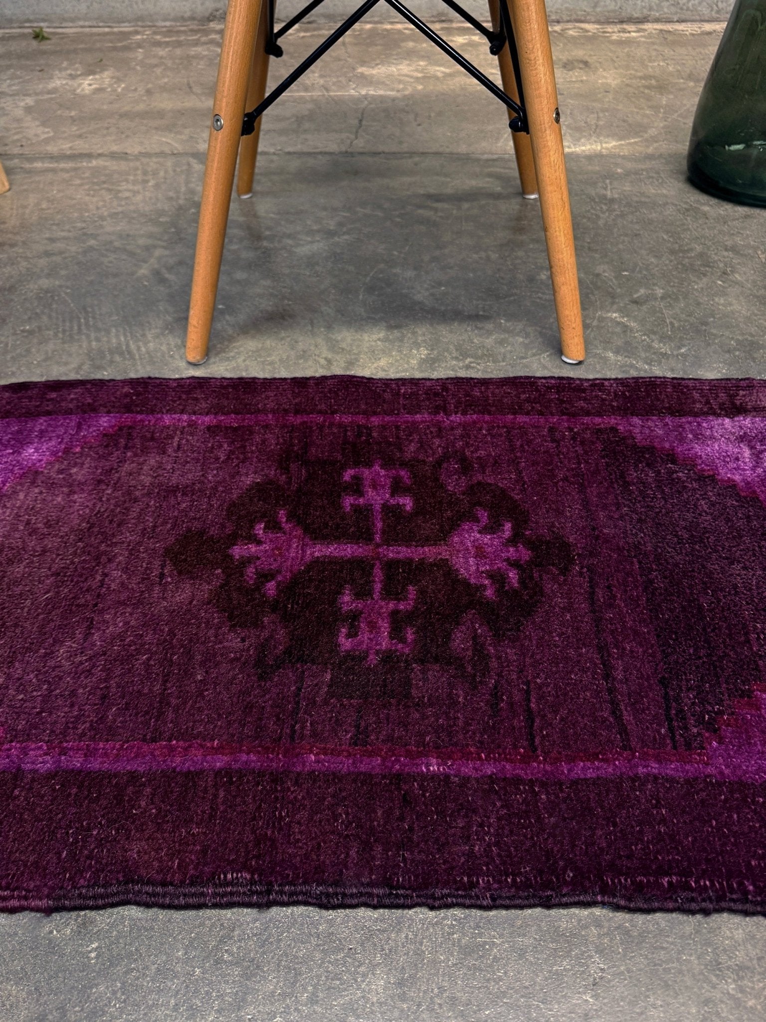 Turkish overdyed mini rug in plum, aubergine, and magenta purple with a shadowed black medallion. Hand-knotted wool, 19x38 inches. One-of-a-kind rug from Indigo Rugs in Burlingame, the best rug shop in the San Francisco Bay Area. Free shipping included.