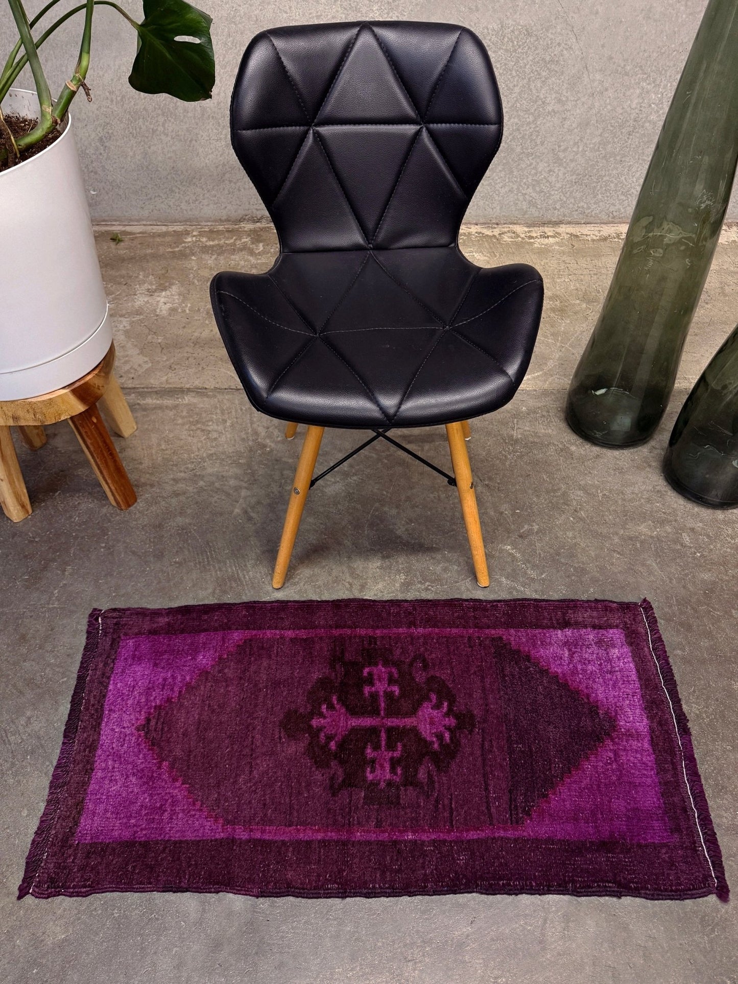 Turkish overdyed mini rug in plum, aubergine, and magenta purple with a shadowed black medallion. Hand-knotted wool, 19x38 inches. One-of-a-kind rug from Indigo Rugs in Burlingame, the best rug shop in the San Francisco Bay Area. Free shipping included.