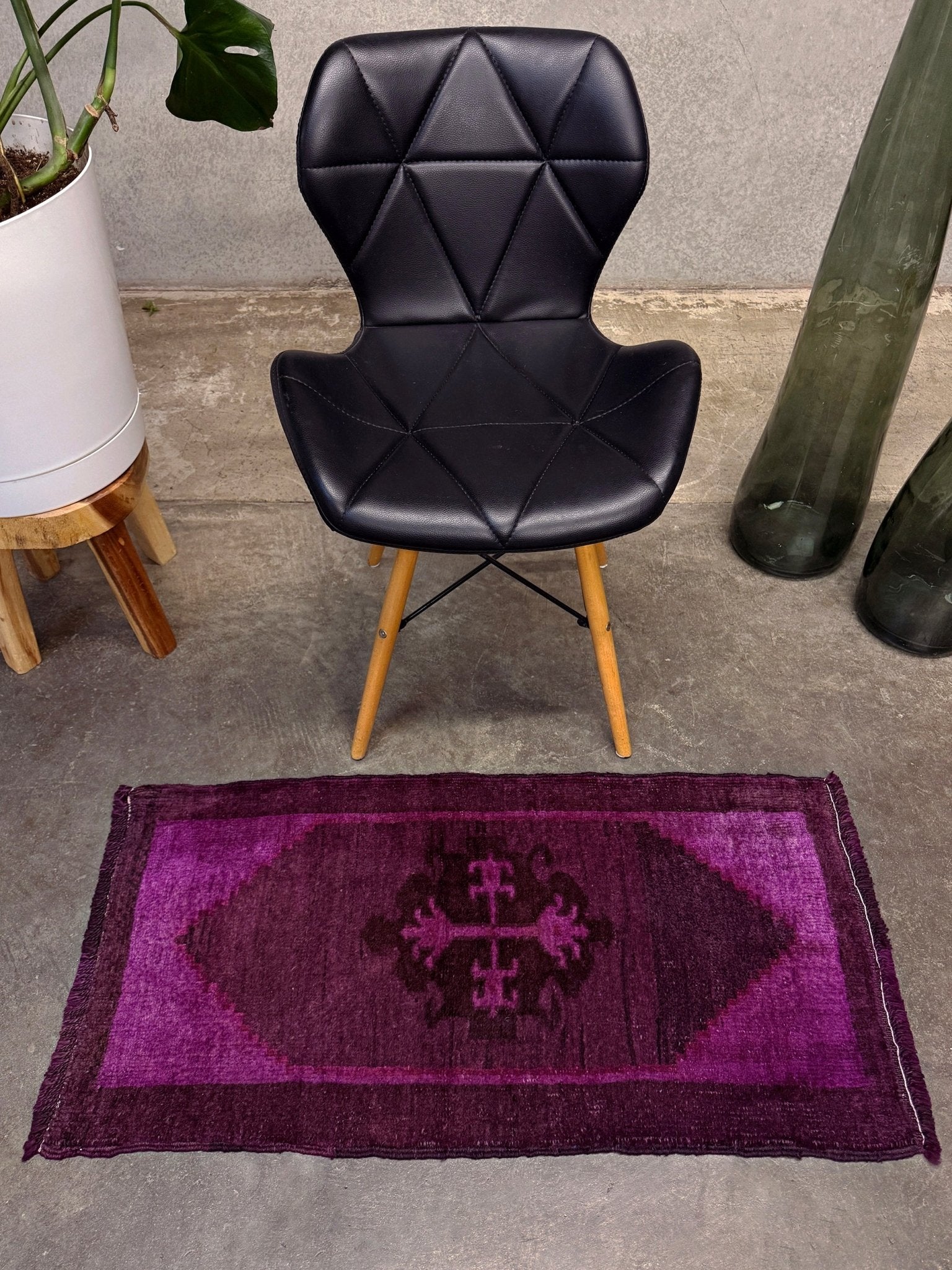 Turkish overdyed mini rug in plum, aubergine, and magenta purple with a shadowed black medallion. Hand-knotted wool, 19x38 inches. One-of-a-kind rug from Indigo Rugs in Burlingame, the best rug shop in the San Francisco Bay Area. Free shipping included.
