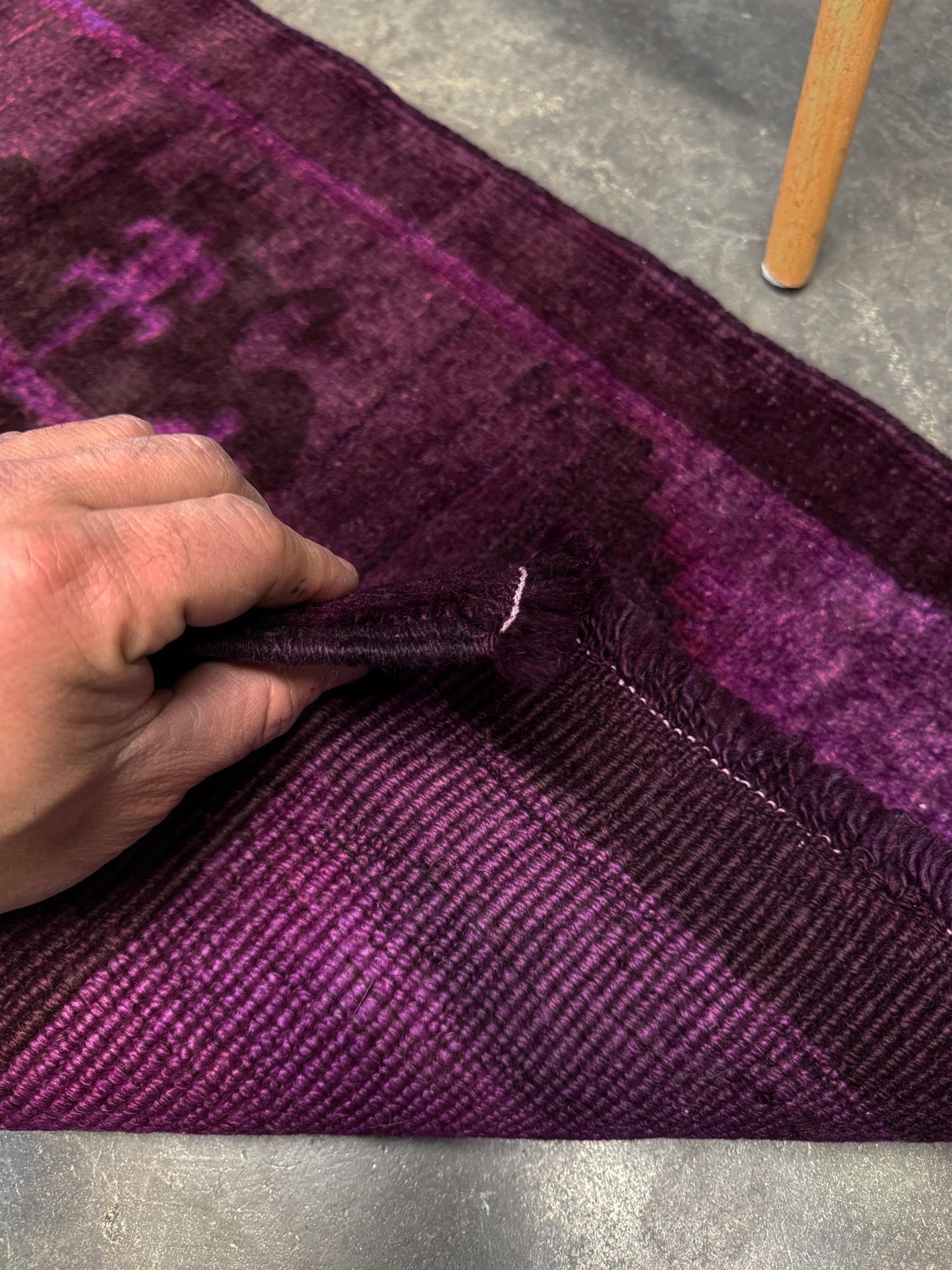 Turkish overdyed mini rug in plum, aubergine, and magenta purple with a shadowed black medallion. Hand-knotted wool, 19x38 inches. One-of-a-kind rug from Indigo Rugs in Burlingame, the best rug shop in the San Francisco Bay Area. Free shipping included.