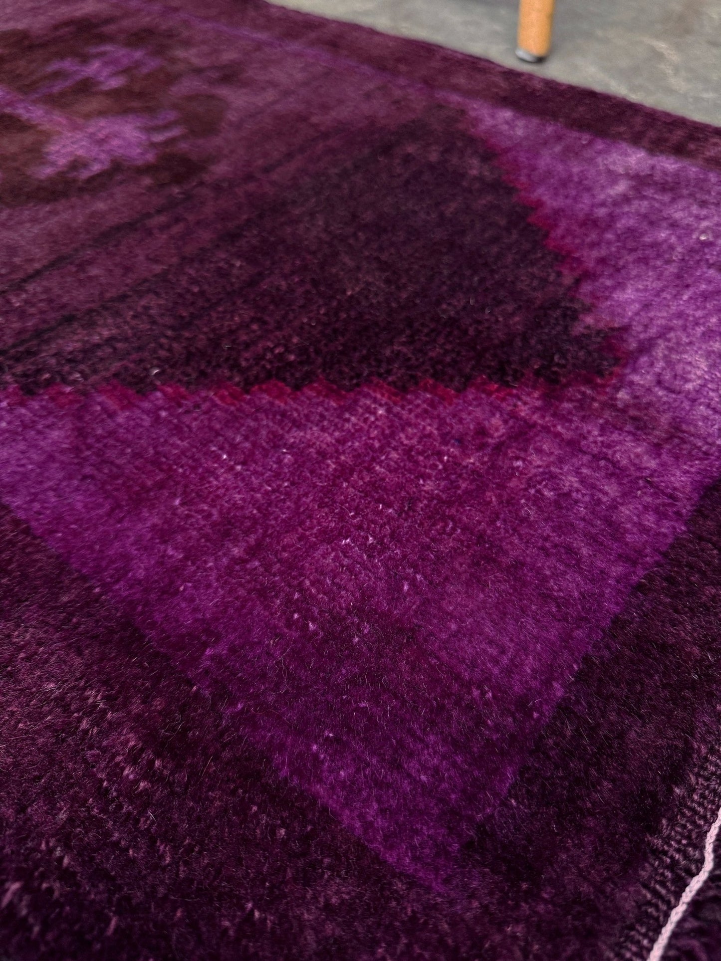 Turkish overdyed mini rug in plum, aubergine, and magenta purple with a shadowed black medallion. Hand-knotted wool, 19x38 inches. One-of-a-kind rug from Indigo Rugs in Burlingame, the best rug shop in the San Francisco Bay Area. Free shipping included.