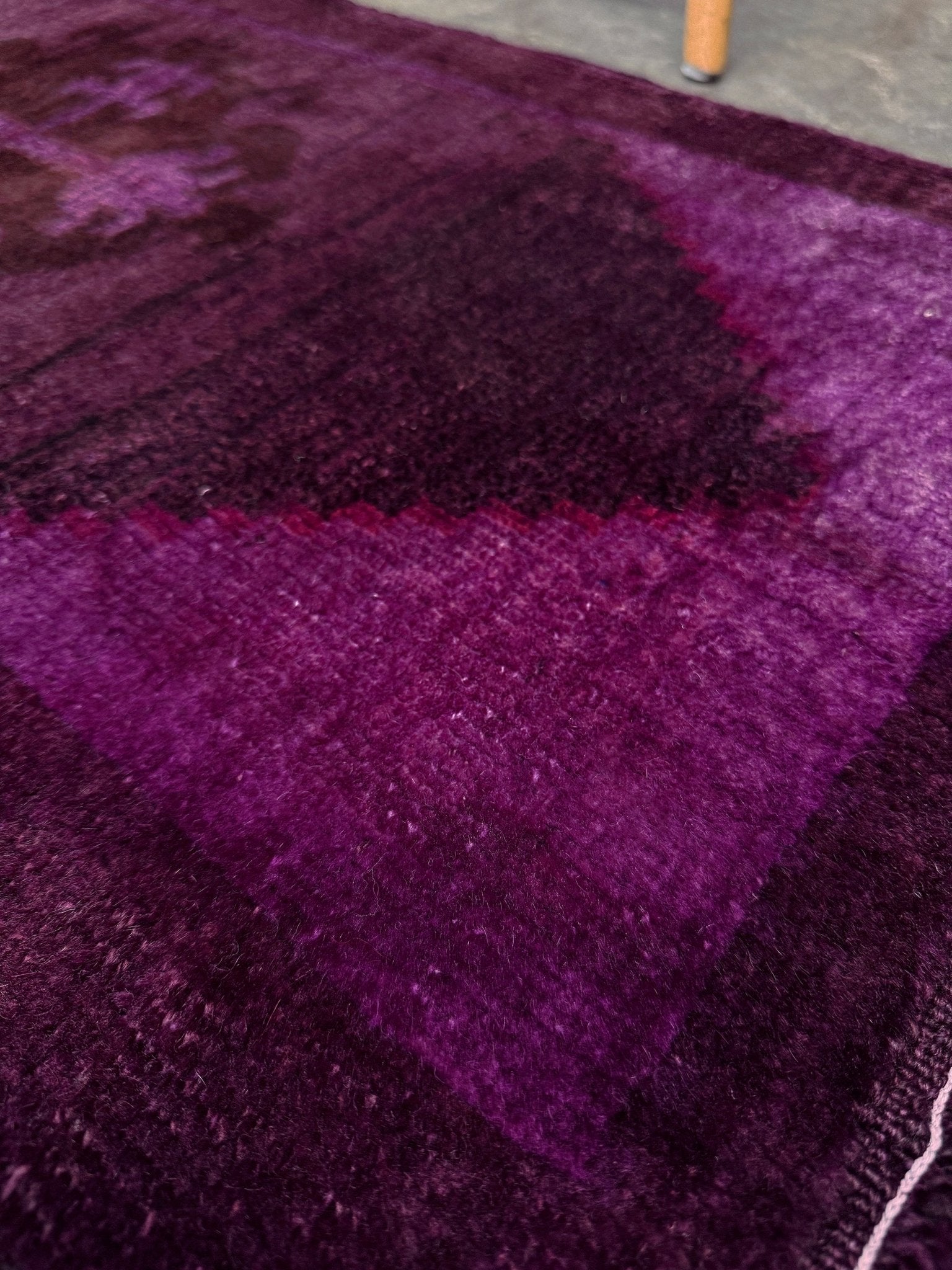 Turkish overdyed mini rug in plum, aubergine, and magenta purple with a shadowed black medallion. Hand-knotted wool, 19x38 inches. One-of-a-kind rug from Indigo Rugs in Burlingame, the best rug shop in the San Francisco Bay Area. Free shipping included.