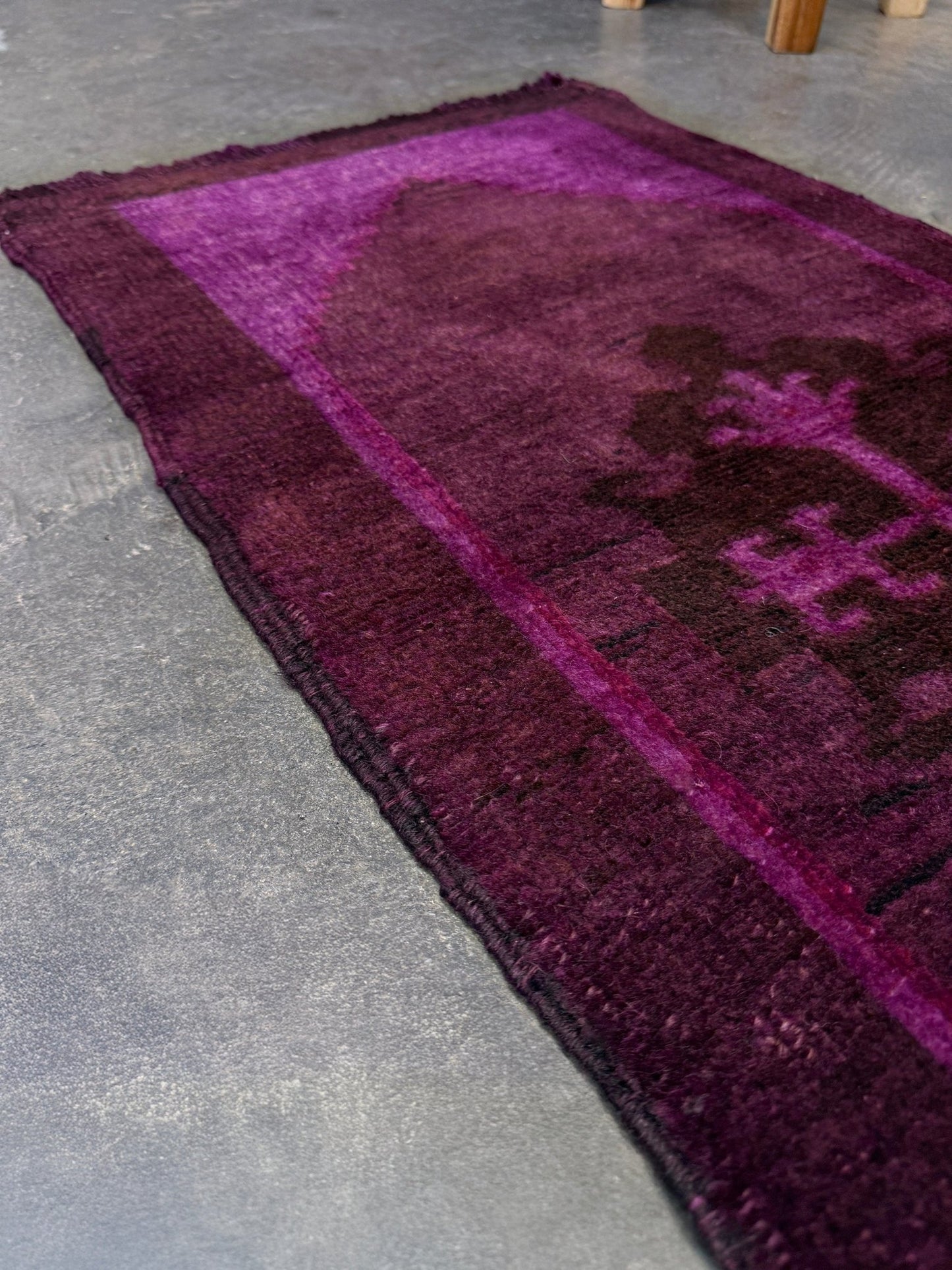 Vintage Turkish overdyed Yastik rug in plum, aubergine, and magenta purple with a shadowed black medallion. Hand-knotted wool, 19x38 inches. One-of-a-kind rug from Indigo Rugs in Burlingame, the best rug shop in the San Francisco Bay Area. Free shipping included.