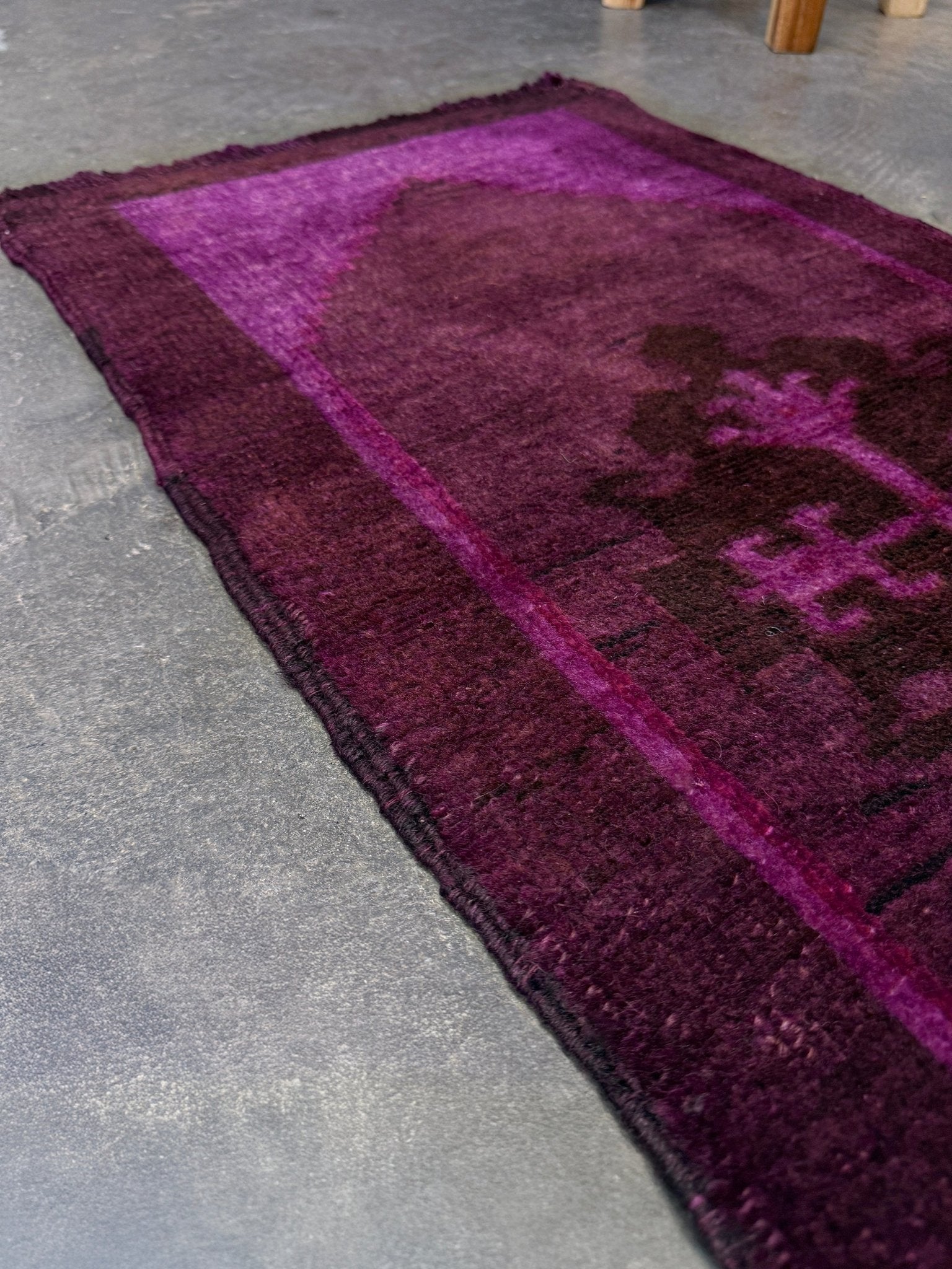 Vintage Turkish overdyed Yastik rug in plum, aubergine, and magenta purple with a shadowed black medallion. Hand-knotted wool, 19x38 inches. One-of-a-kind rug from Indigo Rugs in Burlingame, the best rug shop in the San Francisco Bay Area. Free shipping included.