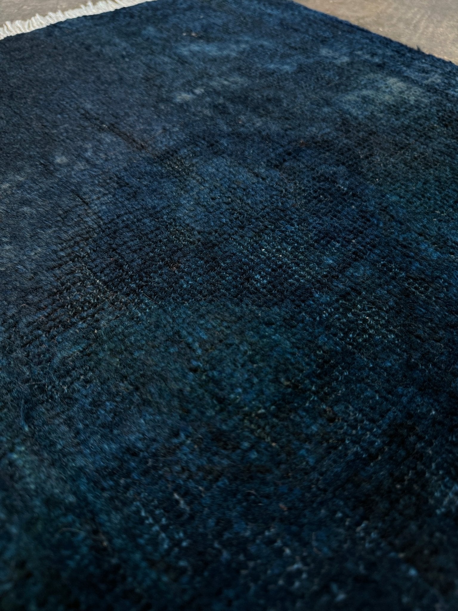 Midnight Blue Turkish overdyed Yastik rug with subtle shadowed motifs. Hand-knotted wool, 21x35 inches. Perfect for: Entryways & apartment foyers, beside the bed, kitchen sink areas, bathroom vanity spots, layered under décor pieces. One-of-a-kind rug from Indigo Rugs in Burlingame, the best rug shop in the San Francisco Bay Area. Free shipping included.