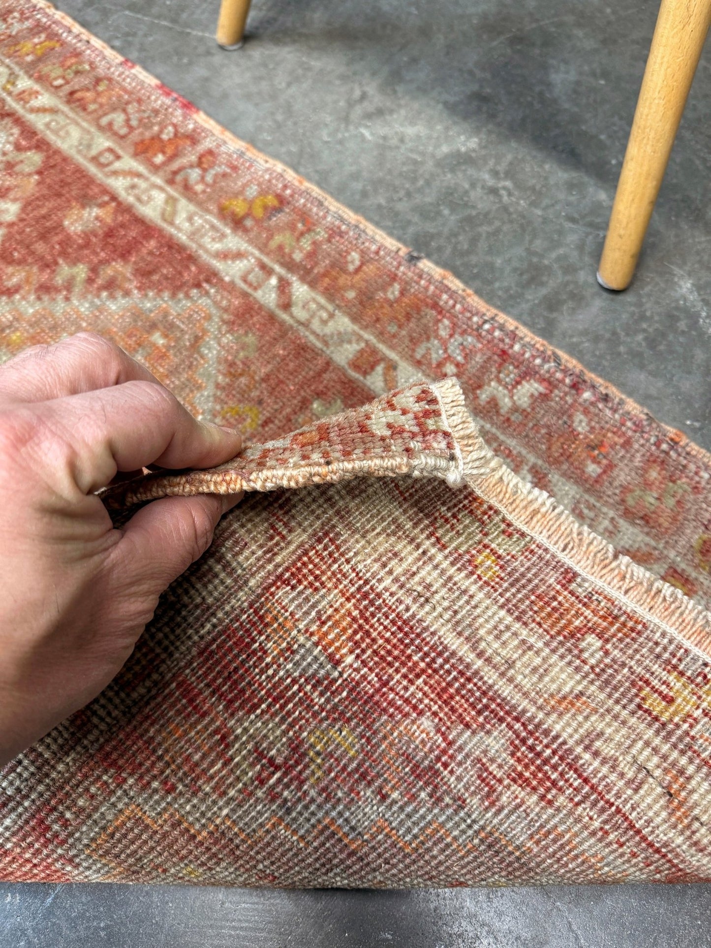 Antique Turkish handmade mini rug with dusty terracotta field, faded peach. Hand-knotted wool, 19x36 inches. Circa 1930s–1950s. Perfect for: Entryways, apartment foyers, beside the bed, kitchen sink areas, bathroom vanity spots. One-of-a-kind piece from Indigo Rugs in Burlingame, the best rug shop in the San Francisco Bay Area. Free shipping included. 