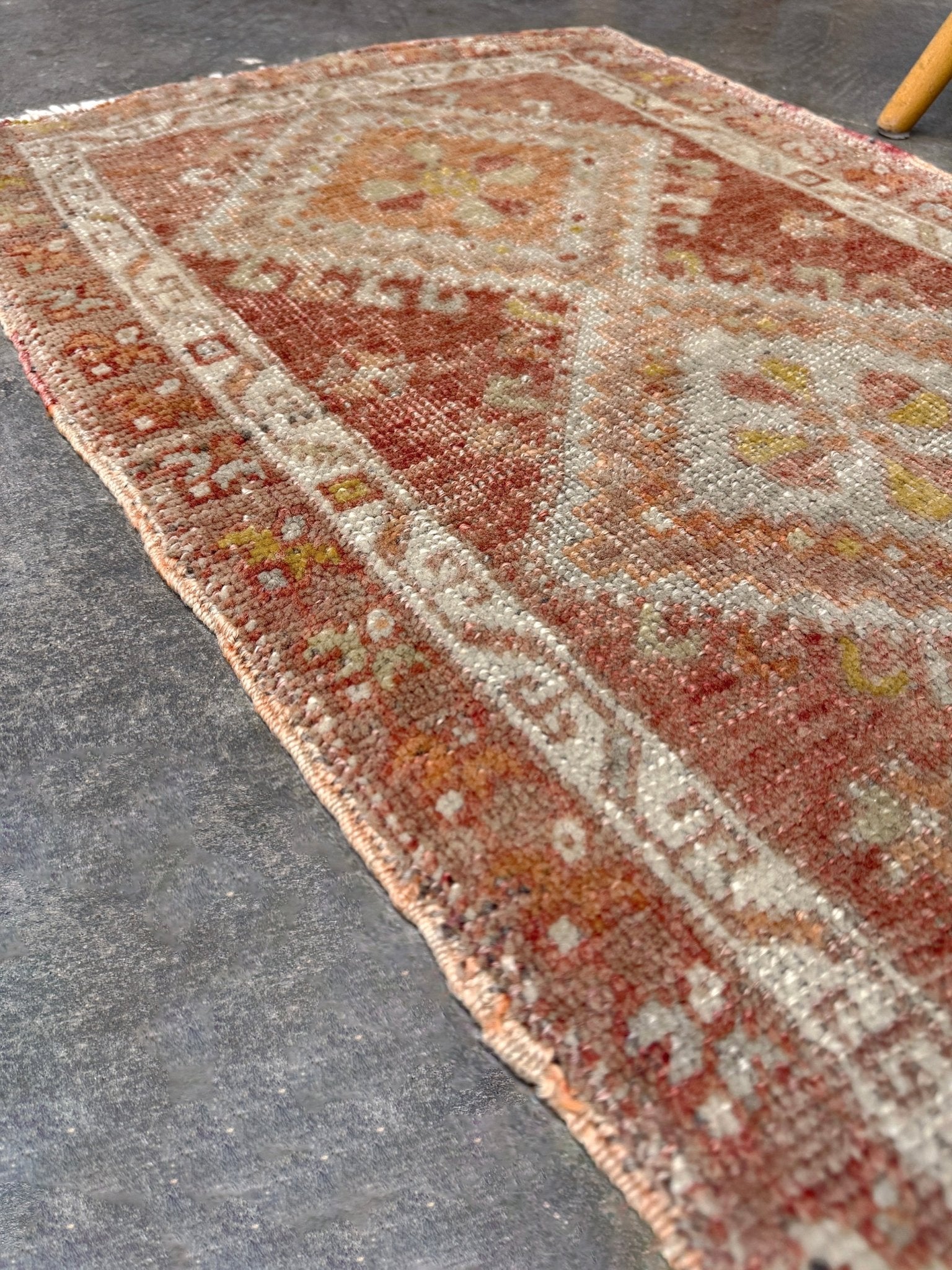 Antique Turkish Yastik rug with dusty terracotta field, faded peach. Hand-knotted wool, 19x36 inches. Circa 1930s–1950s. Perfect for: Entryways, apartment foyers, beside the bed, kitchen sink areas, bathroom vanity spots. One-of-a-kind piece from Indigo Rugs in Burlingame, the best rug shop in the San Francisco Bay Area. Free shipping included. 