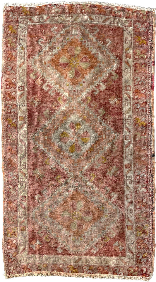 Antique Turkish Yastik rug with dusty terracotta field, faded peach. Hand-knotted wool, 19x36 inches. Circa 1930s–1950s. Perfect for: Entryways &amp; apartment foyers, beside the bed, kitchen sink areas, bathroom vanity spots. One-of-a-kind piece from Indigo Rugs in Burlingame, the best rug shop in the San Francisco Bay Area. Free shipping included. 