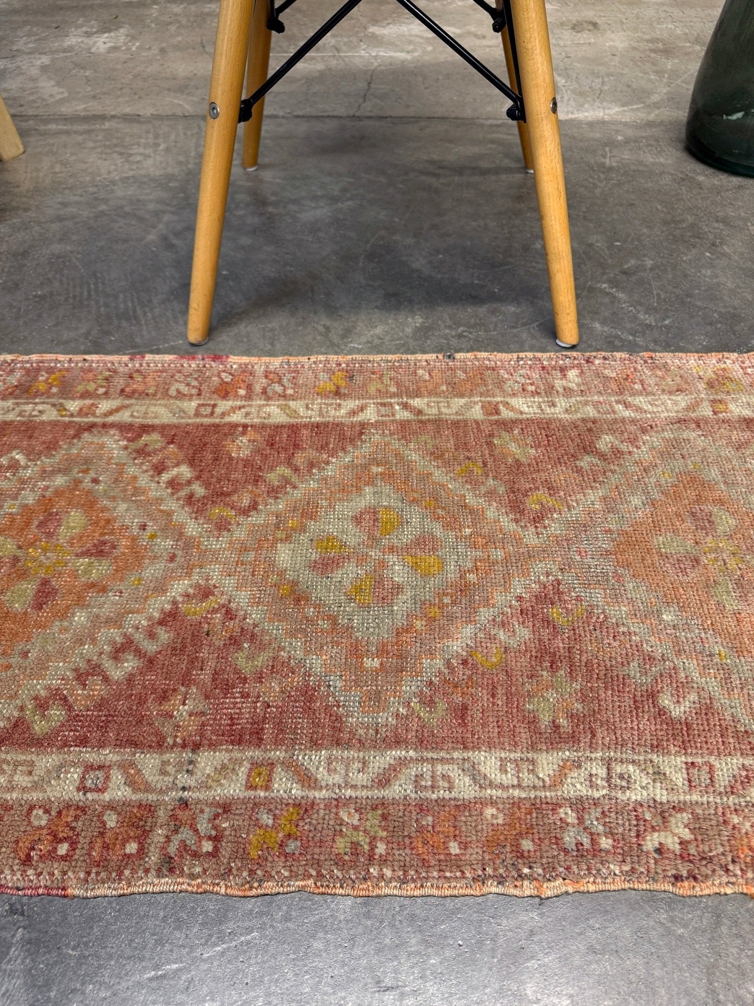 Antique Turkish Yastik rug with dusty terracotta field, faded peach. Hand-knotted wool, 19x36 inches. Circa 1930s–1950s. Perfect for: Entryways, apartment foyers, beside the bed, kitchen sink areas, bathroom vanity spots. One-of-a-kind piece from Indigo Rugs in Burlingame, the best rug shop in the San Francisco Bay Area. Free shipping included. 