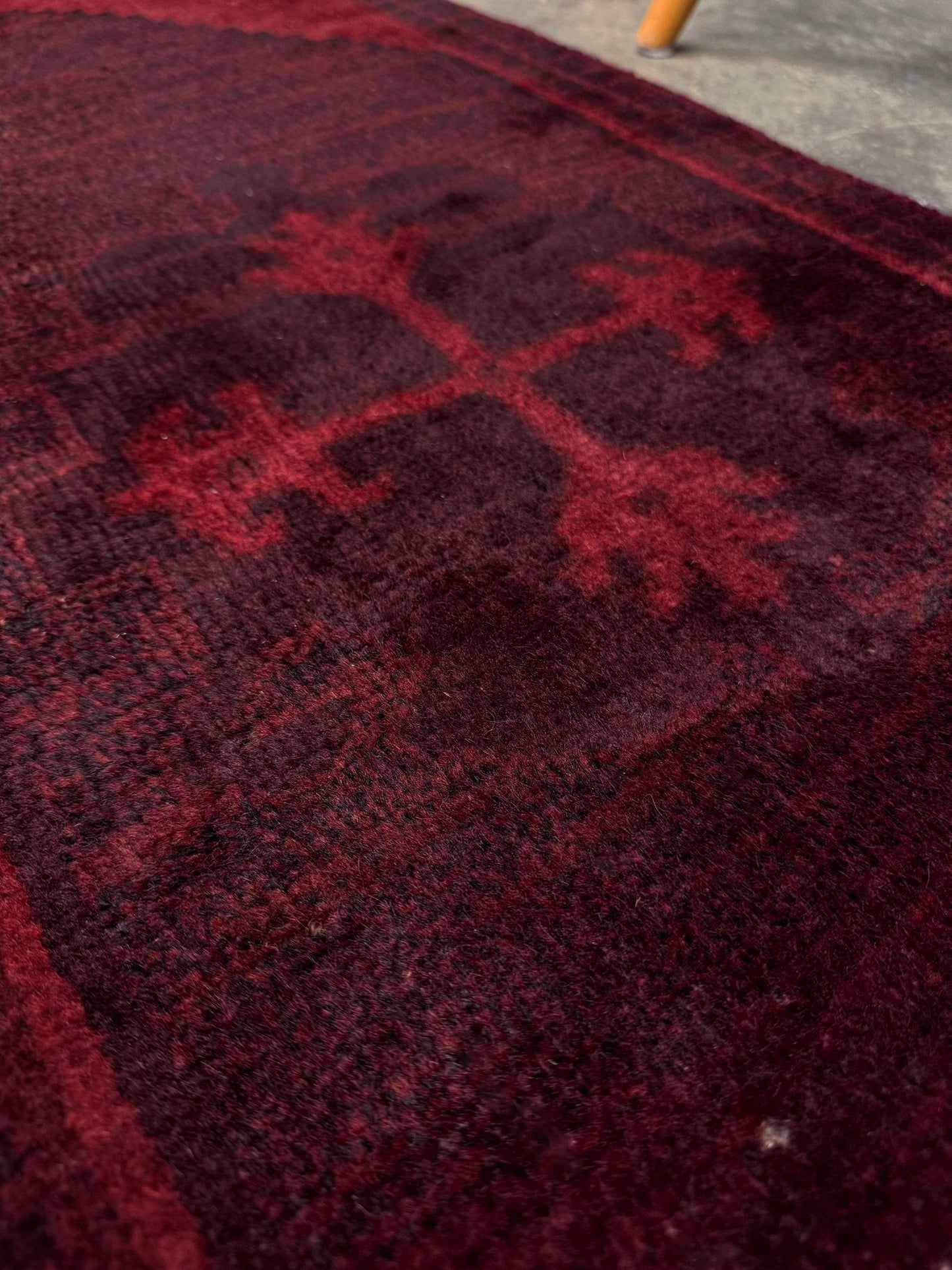 Vintage Turkish overdyed Yastik rug in ruby red tones with subtle shadowed motifs. Hand-knotted wool, 18x40 inches. Perfect for: Entryway, apartment foyers, beside the bed, kitchen sink areas, bathroom vanity spots, layered under décor piecesOne-of-a-kind rug from Indigo Rugs in Burlingame, the best rug shop in the San Francisco Bay Area. Free shipping included.