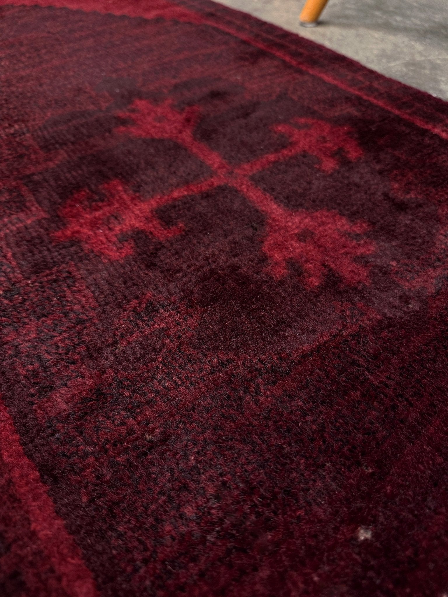Vintage Turkish overdyed Yastik rug in ruby red tones with subtle shadowed motifs. Hand-knotted wool, 18x40 inches. Perfect for: Entryway, apartment foyers, beside the bed, kitchen sink areas, bathroom vanity spots, layered under décor piecesOne-of-a-kind rug from Indigo Rugs in Burlingame, the best rug shop in the San Francisco Bay Area. Free shipping included.