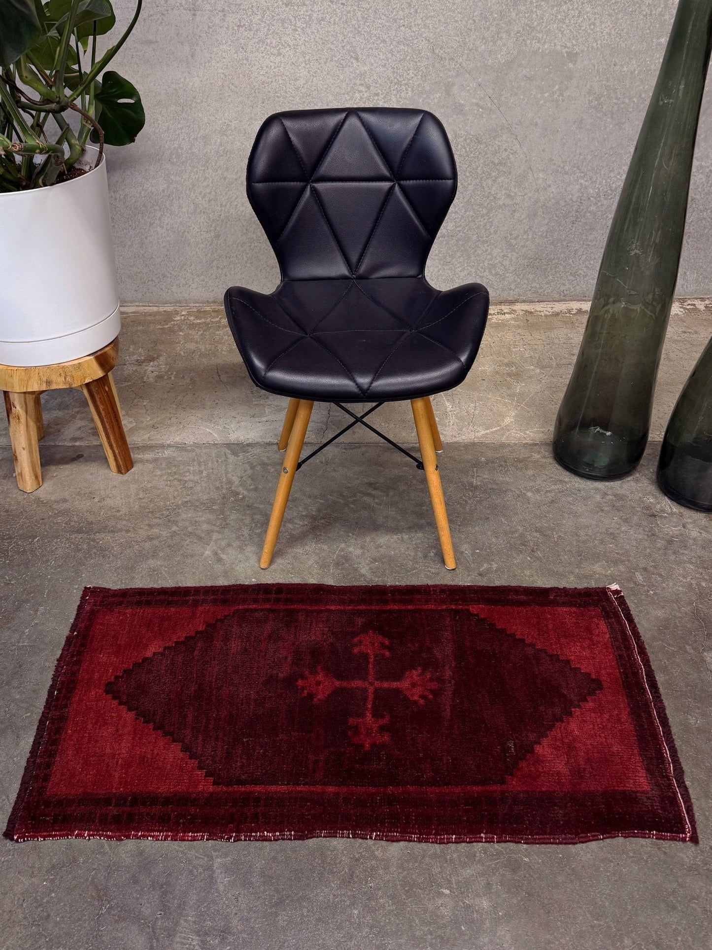 Vintage Turkish overdyed Yastik rug in ruby red tones with subtle shadowed motifs. Hand-knotted wool, 18x40 inches. Perfect for: Entryway, apartment foyers, beside the bed, kitchen sink areas, bathroom vanity spots, layered under décor piecesOne-of-a-kind rug from Indigo Rugs in Burlingame, the best rug shop in the San Francisco Bay Area. Free shipping included.