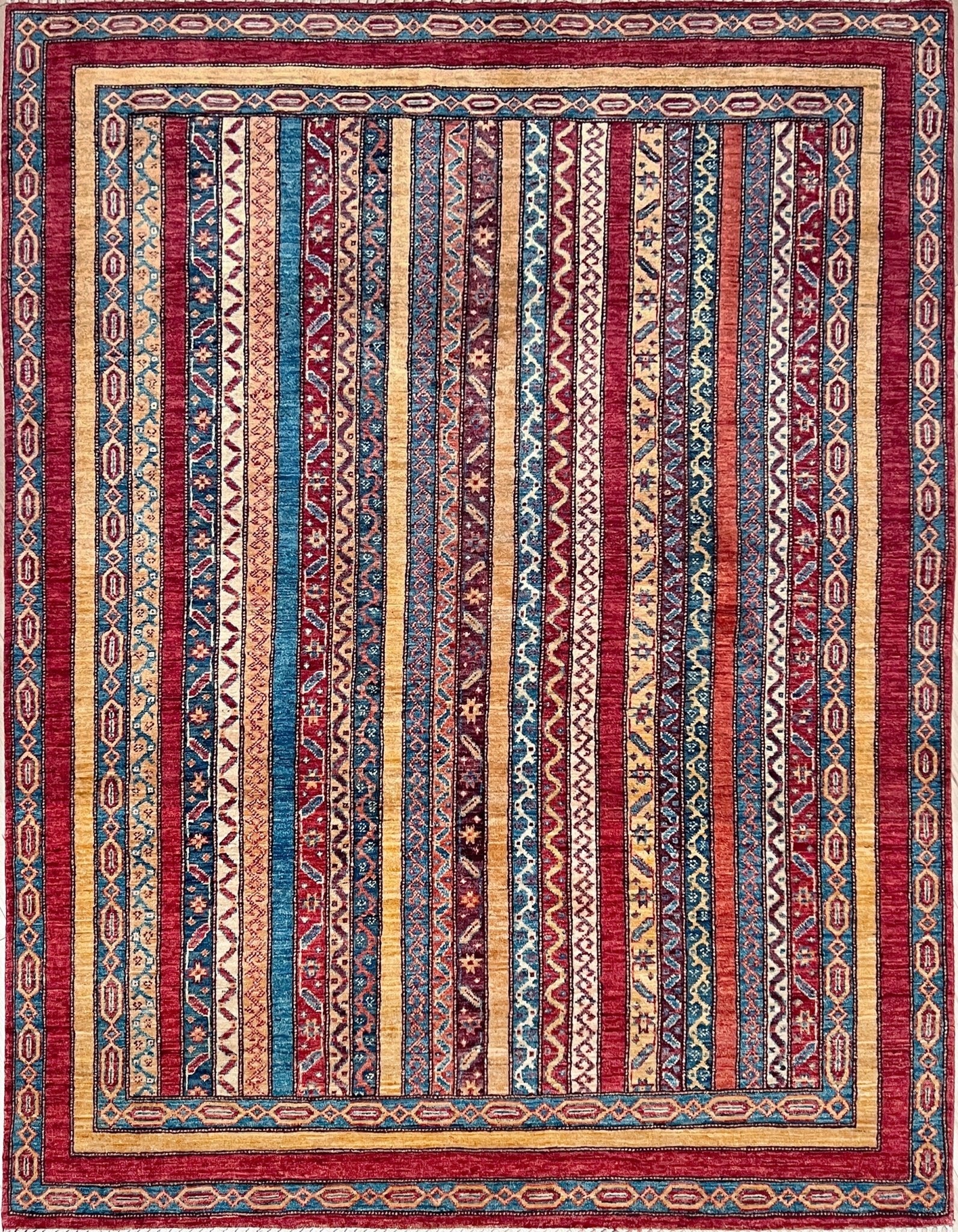 Handmade Turkish Shawl Rug with vibrant vertical stripes in red, blue, yellow, and cream, featuring intricate tribal motifs from the best luxury rug shop in the San Francisco Bay Area. High-quality wool rug at an affordable price with free shipping. Perfect for adding a touch of Turkish craftsmanship to any room. Ideal statement piece for living rooms, bedrooms, and entryways.