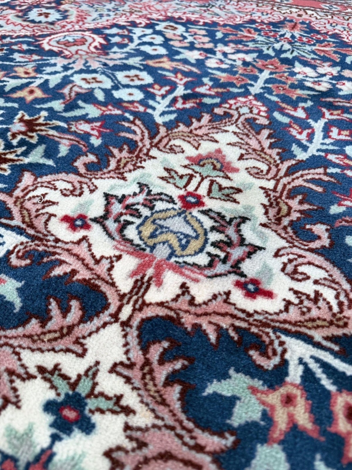Blue vintage Turkish rug with deep blue field,  floral medallion, handmade wool 7x9 from Indigo Rugs Burlingame Bay Area.