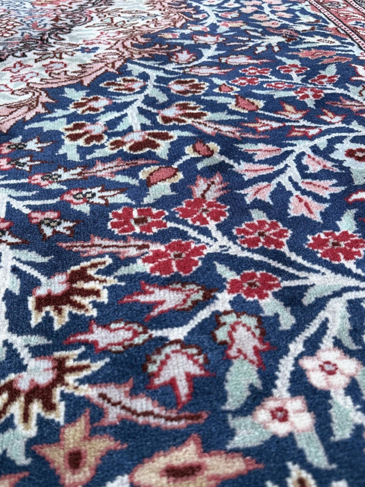 Blue vintage Turkish rug with deep blue field,  floral medallion, handmade wool 7x9 from Indigo Rugs Burlingame Bay Area.