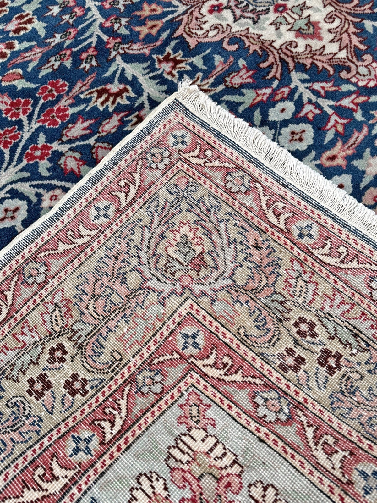 Blue vintage Turkish rug with deep blue field,  floral medallion, handmade wool 7x9 from Indigo Rugs Burlingame Bay Area.