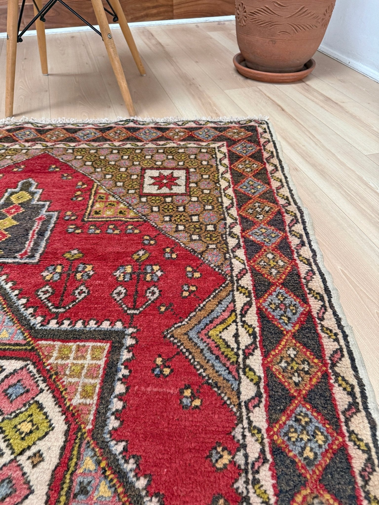 5x7 Vintage Turkish rug in rich crimson red with intricate medallion design, —perfect for bedroom, living room, or dining space. High-quality wool rug with vibrant hues of mustard yellow, olive green, and pale pink. Available at the best rug shop in San Mateo, SF Bay Area, with free shipping. Timeless character and craftsmanship for a stylish, cozy home.