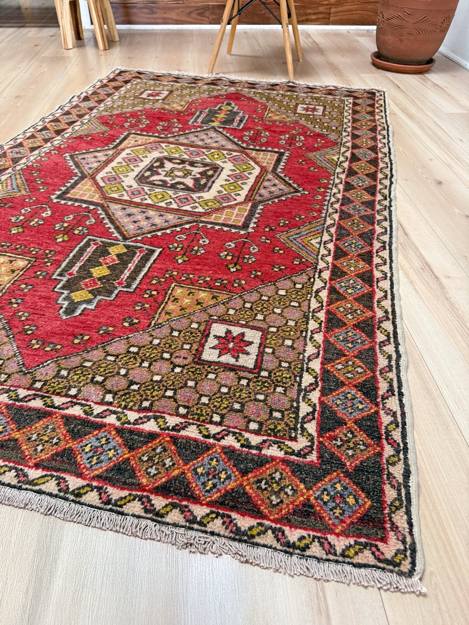 5x7 Vintage Turkish rug in rich crimson red with intricate medallion design, floral and geometric motifs—perfect for bedroom, living room, or dining space. High-quality wool rug with vibrant hues of mustard yellow, olive green, and pale pink. Available at the best rug shop in San Mateo, SF Bay Area, with free shipping. Timeless character and craftsmanship for a stylish, cozy home.