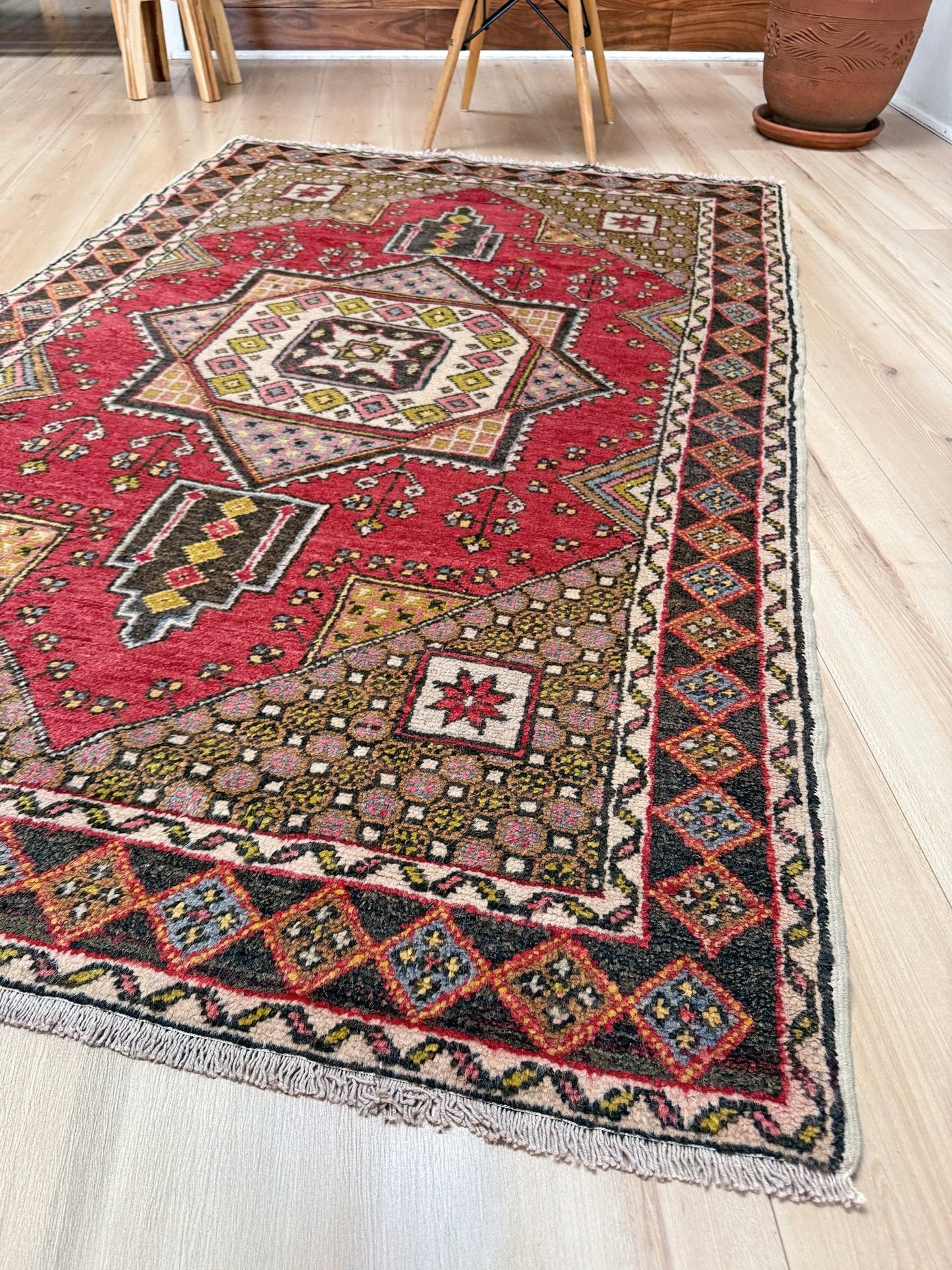 5x7 Vintage Turkish rug in rich crimson red with intricate medallion design, —perfect for bedroom, living room, or dining space. High-quality wool rug with vibrant hues of mustard yellow, olive green, and pale pink. Available at the best rug shop in San Mateo, SF Bay Area, with free shipping. Timeless character and craftsmanship for a stylish, cozy home.