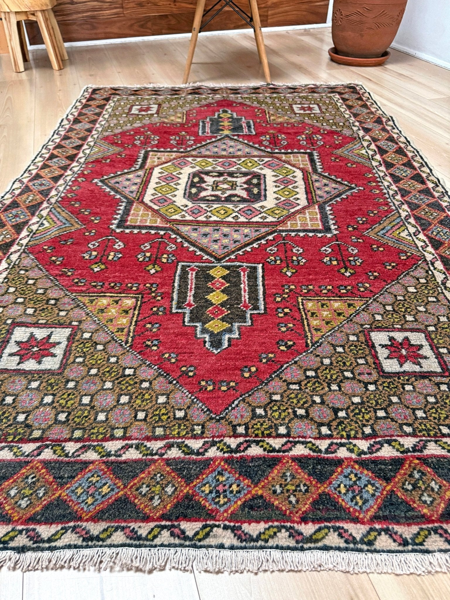 5x7 Vintage Turkish rug in rich crimson red with intricate medallion design, —perfect for bedroom, living room, or dining space. High-quality wool rug with vibrant hues of mustard yellow, olive green, and pale pink. Available at the best rug shop in San Mateo, SF Bay Area, with free shipping. Timeless character and craftsmanship for a stylish, cozy home.