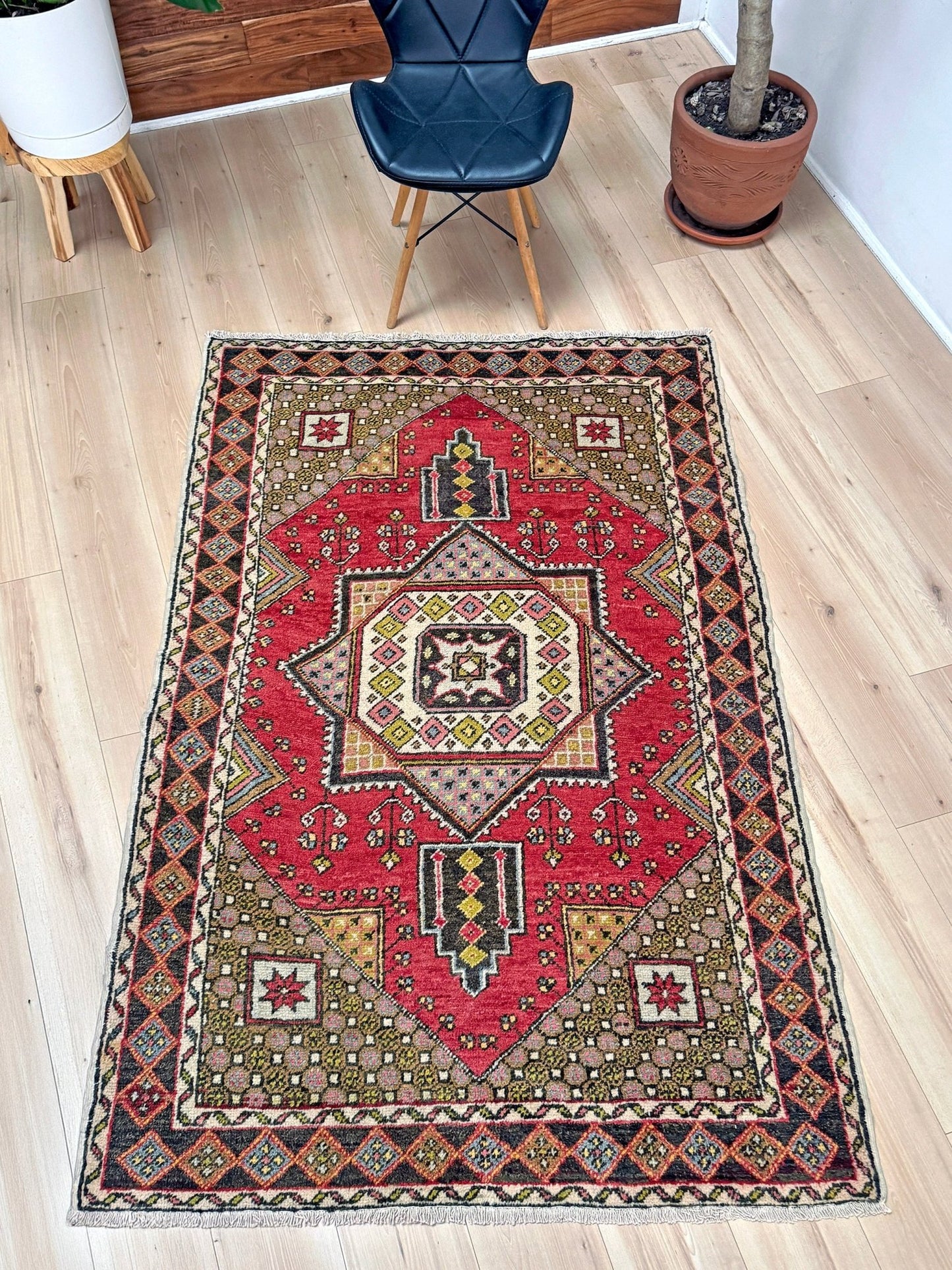5x7 Vintage Turkish rug in rich crimson red with intricate medallion design, —perfect for bedroom, living room, or dining space. High-quality wool rug with vibrant hues of mustard yellow, olive green, and pale pink. Available at the best rug shop in San Mateo, SF Bay Area, with free shipping. Timeless character and craftsmanship for a stylish, cozy home.
