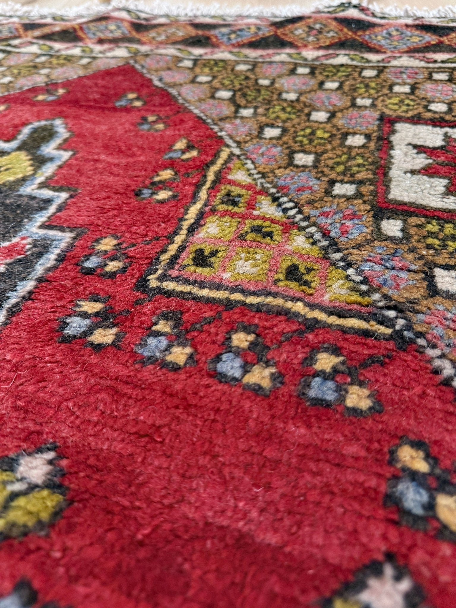 5x7 Vintage Turkish rug in rich crimson red with intricate medallion design, —perfect for bedroom, living room, or dining space. High-quality wool rug with vibrant hues of mustard yellow, olive green, and pale pink. Available at the best rug shop in San Mateo, SF Bay Area, with free shipping. Timeless character and craftsmanship for a stylish, cozy home.