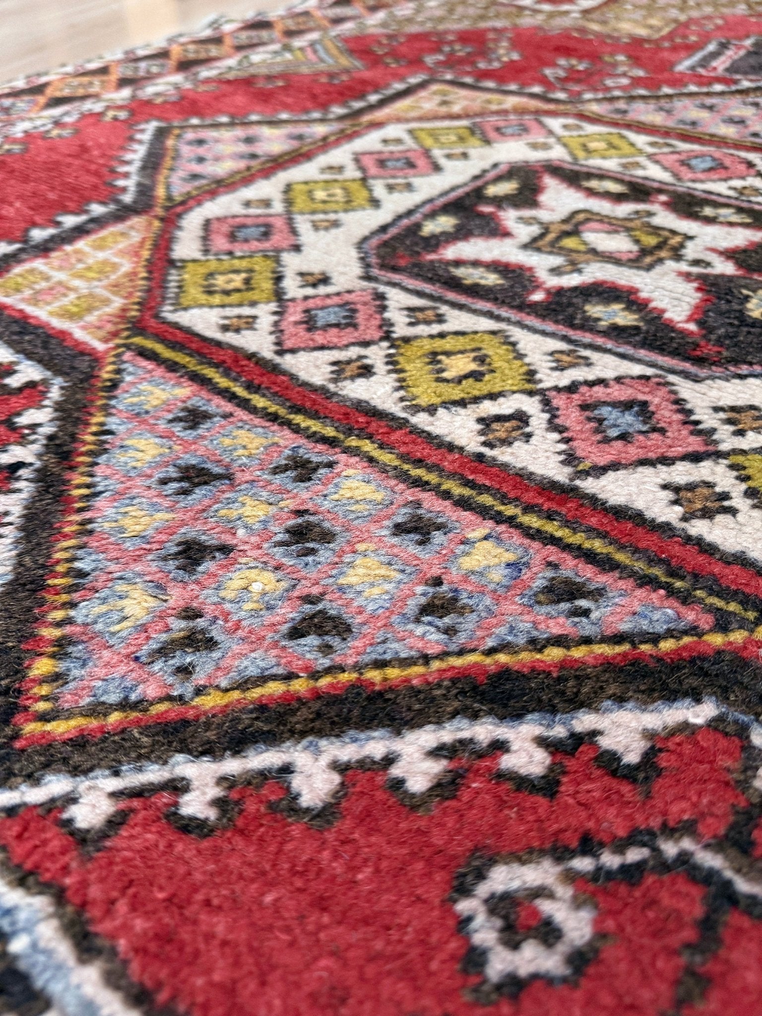 5x7 Vintage Turkish rug in rich crimson red with intricate medallion design, —perfect for bedroom, living room, or dining space. High-quality wool rug with vibrant hues of mustard yellow, olive green, and pale pink. Available at the best rug shop in San Mateo, SF Bay Area, with free shipping. Timeless character and craftsmanship for a stylish, cozy home.
