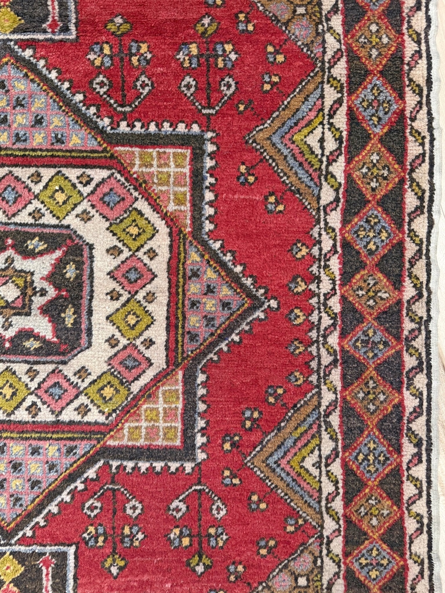 5x7 Vintage Turkish rug in rich crimson red with intricate medallion design, —perfect for bedroom, living room, or dining space. High-quality wool rug with vibrant hues of mustard yellow, olive green, and pale pink. Available at the best rug shop in San Mateo, SF Bay Area, with free shipping. Timeless character and craftsmanship for a stylish, cozy home.