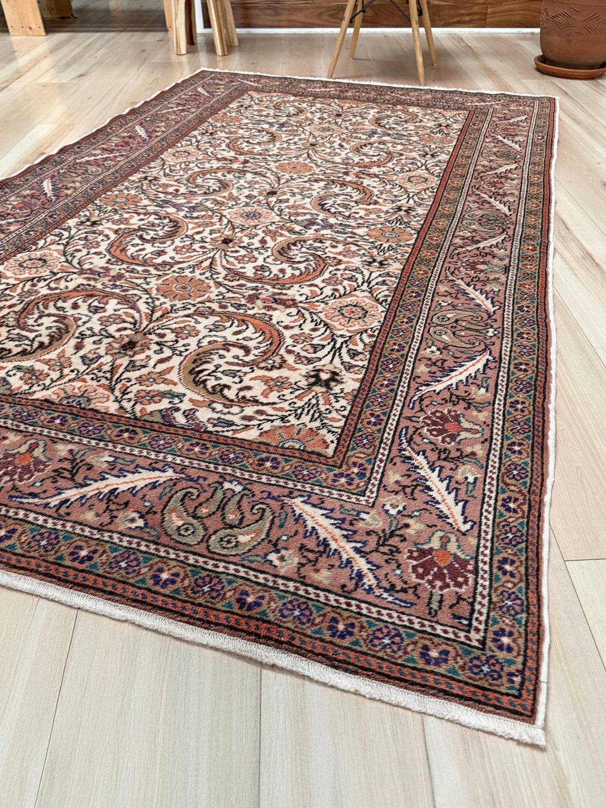 Vintage floral handmade Turkish wool rug with an ivory field and scrolling botanical motifs in terracotta, soft rose, olive green,  5x7 rug from Indigo Rugs in Burlingame, the best rug shop in the San Francisco Bay Area. Free shipping included.