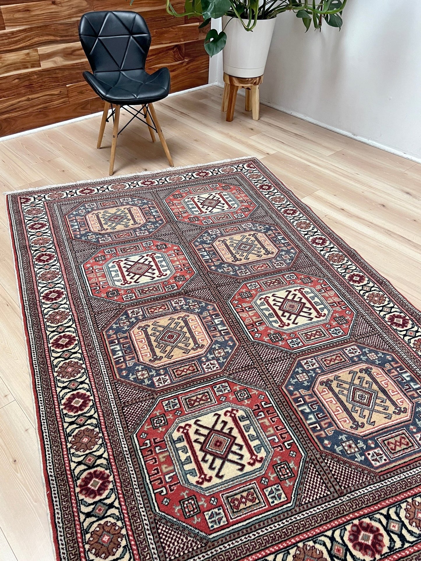 Luxurious 5x7 Turkish tribal rug with geometric 'chest' octagonal medallions and intricate checkered pattern in brick red, deep navy blue, ivory cream, and dusty peach hues. Handmade and available from the best luxury rug shop in the San Francisco Bay Area. Free shipping