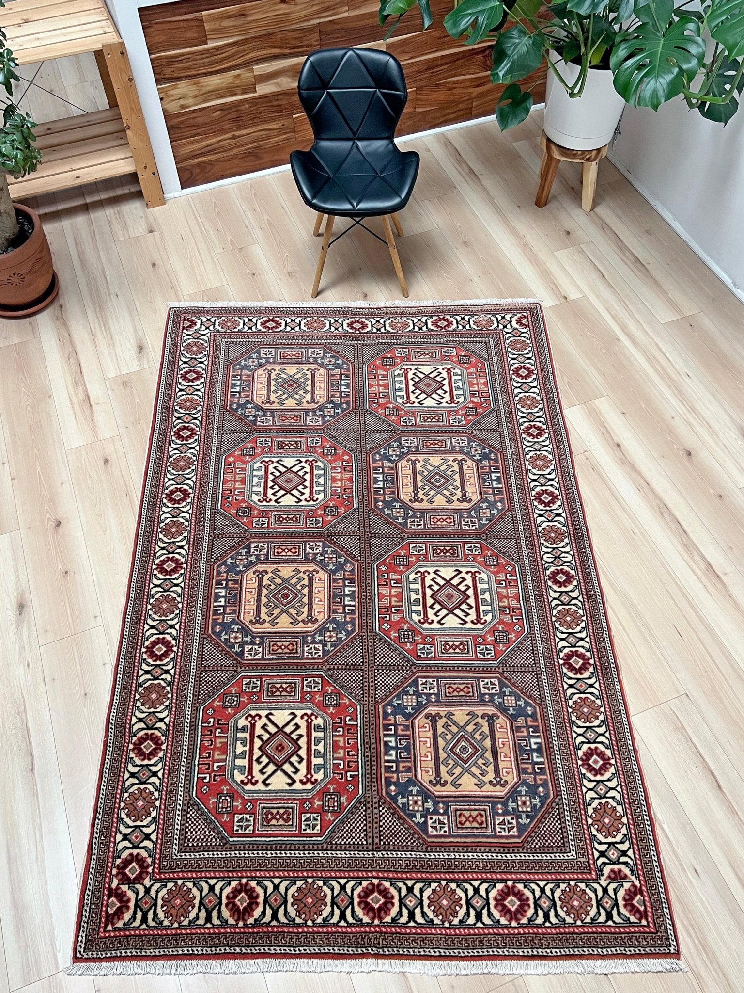 Luxurious 5x7 Turkish tribal rug with geometric 'chest' octagonal medallions and intricate checkered pattern in brick red, deep navy blue, ivory cream, and dusty peach hues. Handmade and available from the best luxury rug shop in the San Francisco Bay Area. Free shipping