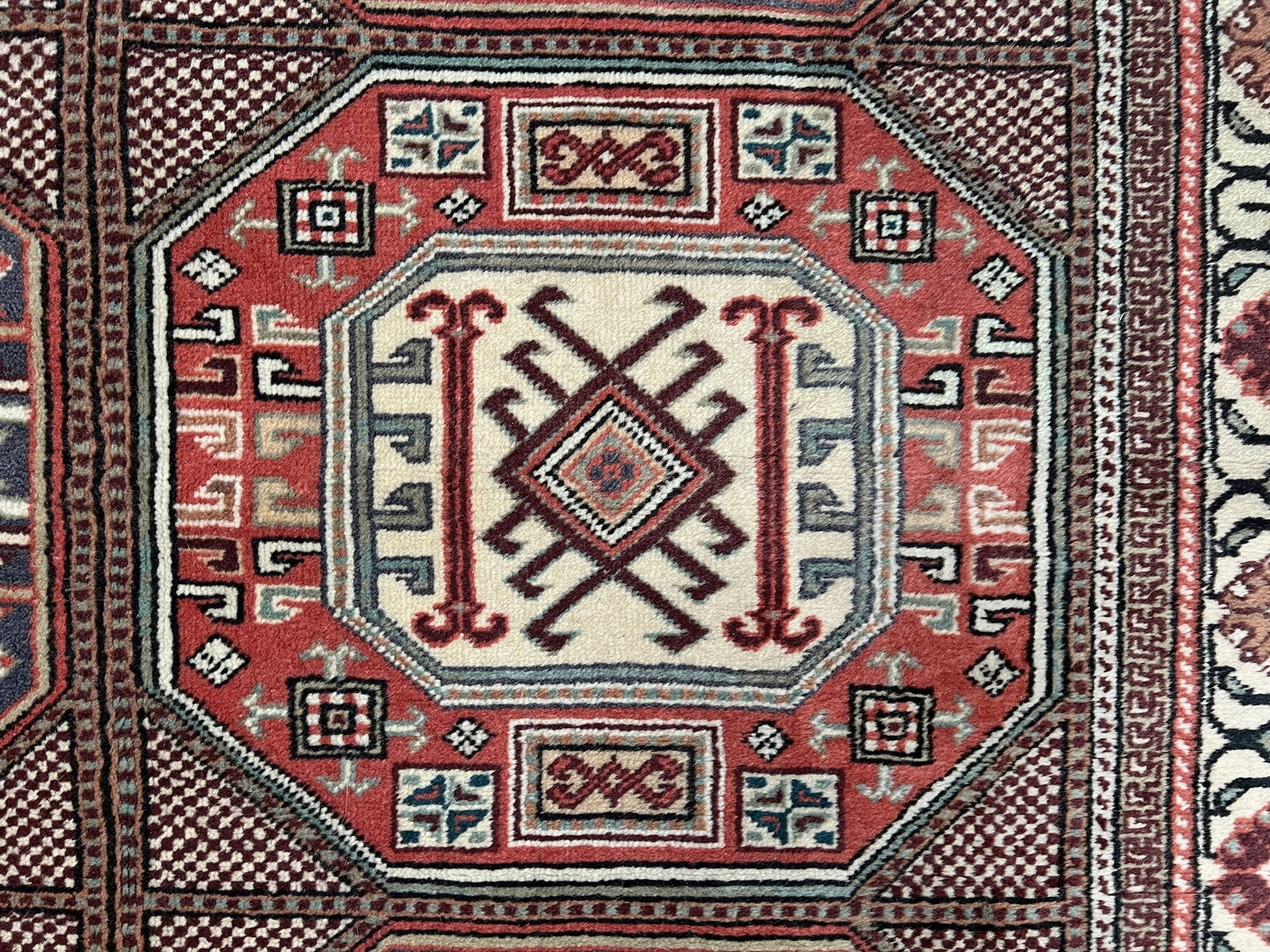 Luxurious 5x7 Turkish tribal rug with geometric 'chest' octagonal medallions and intricate checkered pattern in earth colors. Handmade and available from the best luxury rug shop in the San Francisco Bay Area. Free shipping