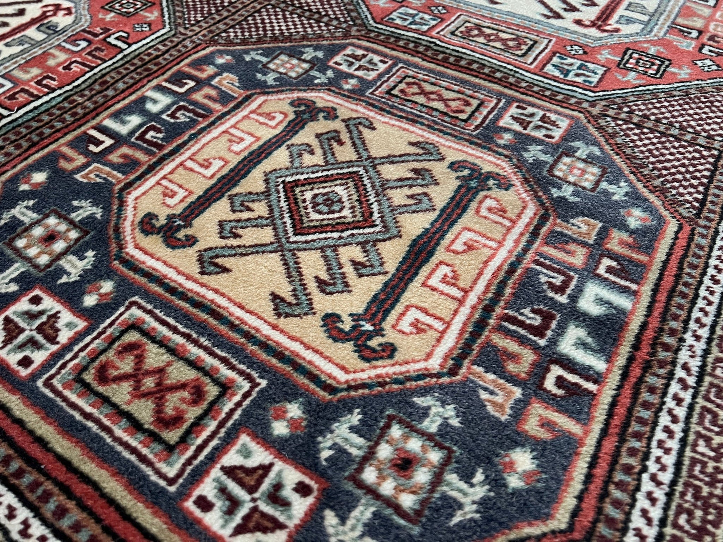 Luxurious 5x7 Turkish tribal rug with geometric 'chest' octagonal medallions and intricate checkered pattern in earth colors. Handmade and available from the best luxury rug shop in the San Francisco Bay Area. Free shipping