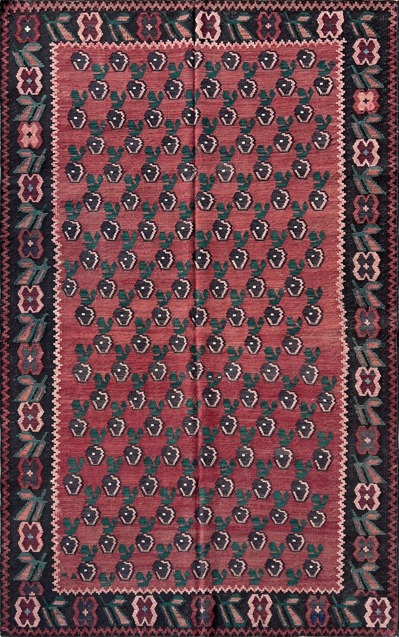 5x7 vintage Armenian Kilim flatweave rug with a crimson red backdrop, decorated with intricate floral motifs in forest green, blush pink, charcoal black, and creamy yellow accents. This handmade rug, available from the best kilim rug shop in the San Francisco Bay Area, is a versatile piece perfect for a living room, bedroom, nursery, kitchen, or dining area. Its lightweight yet durable craftsmanship makes it both a functional and decorative choice. Free shipping included!