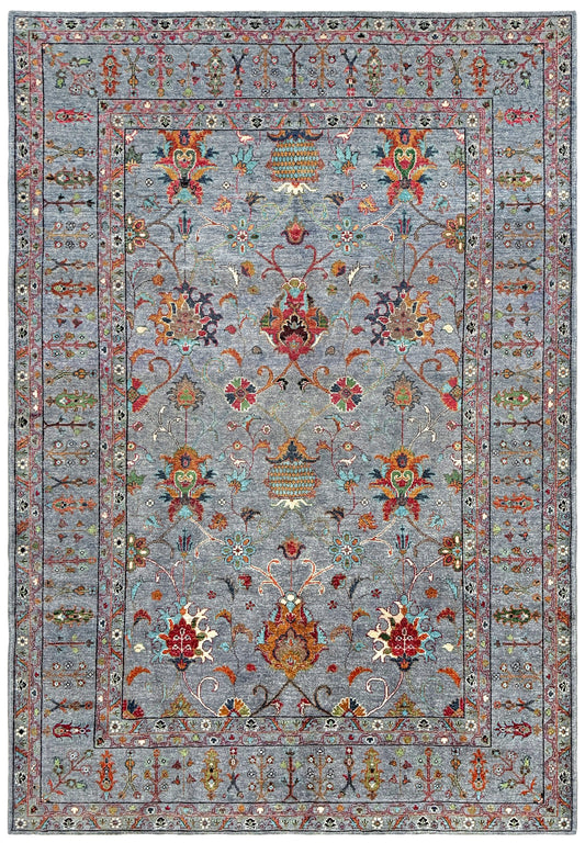 A rectangular area rug with a traditional ornamental pattern, featuring a dusty blue-gray field and border with red, orange, green, and cream floral motifs.
Blue gray Ziegler Turkish rug with floral accents, handmade wool 7x9 area rug from Indigo Rugs Burlingame Bay Area.