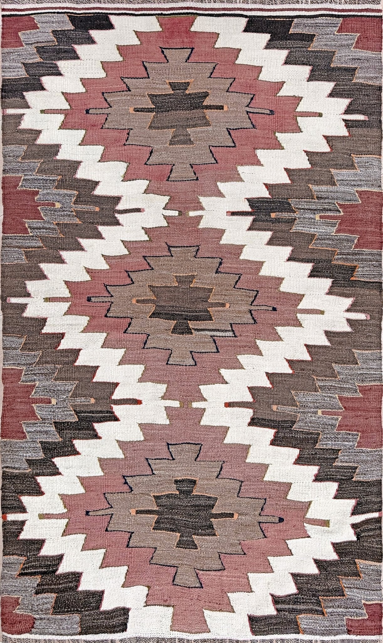 Vintage Mut kilim rug with Navajo-style diamond medallions in dusty rose, taupe, and chocolate brown — handmade Turkish flatweave from 1970s, available at Indigo Rugs, Burlingame / San Francisco Bay Area.”