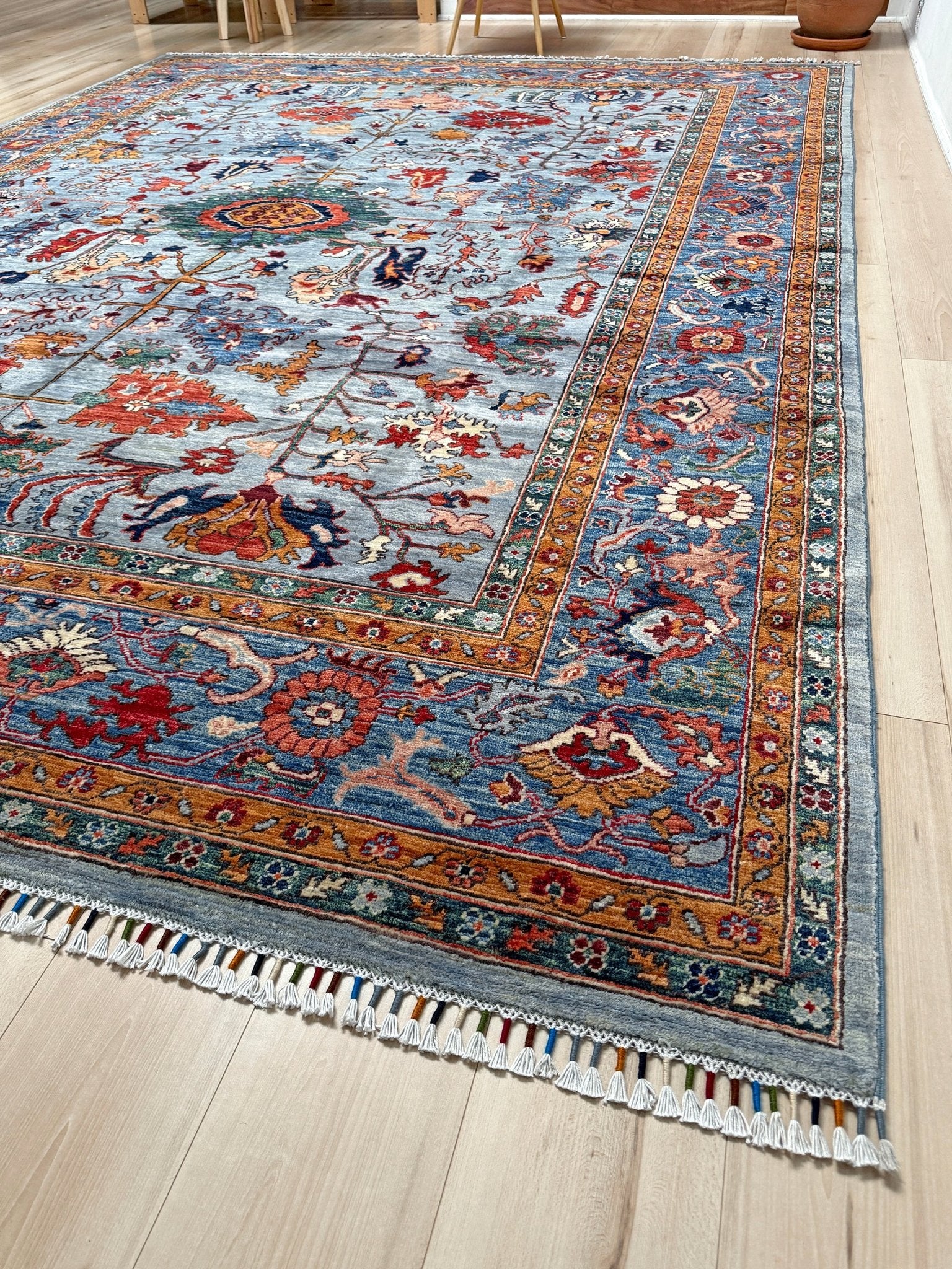 9x12 handmade luxury floral rug with dusty blue background and rich cobalt border, exclusive to the best rug shop in Burlingame CA, SF Bay Area – perfect for bedroom, living room, or dining room décor, with free shipping included.